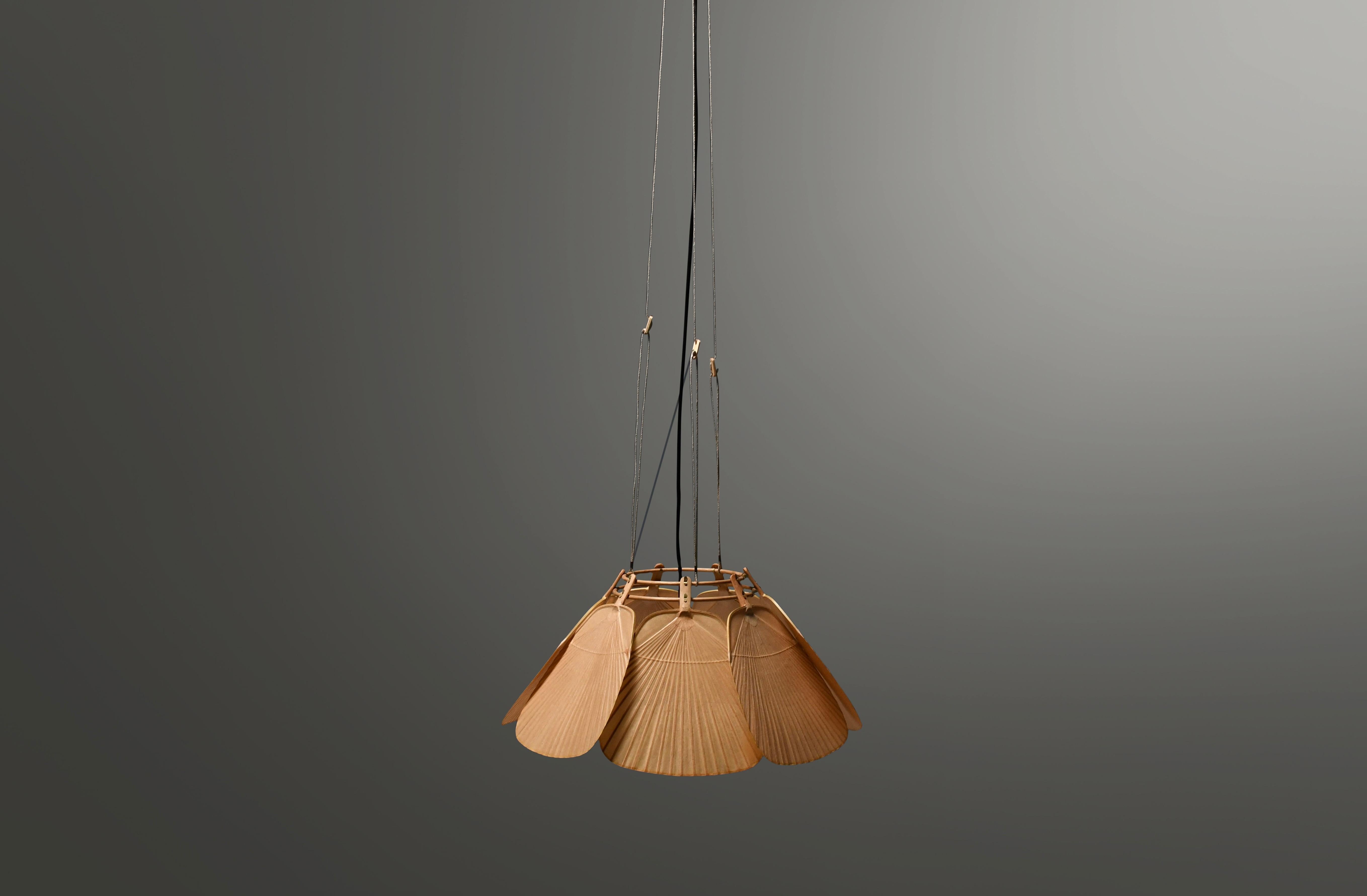 Rare Uchiwa Ju-Yon chandelier in very good condition. 

Designed by Ingo Maurer for M design, Germany. 

Two available!

This chandelier is handmade from bamboo and Japanese rice paper. 

The lamp consists of seven fans hanging from a bamboo frame.