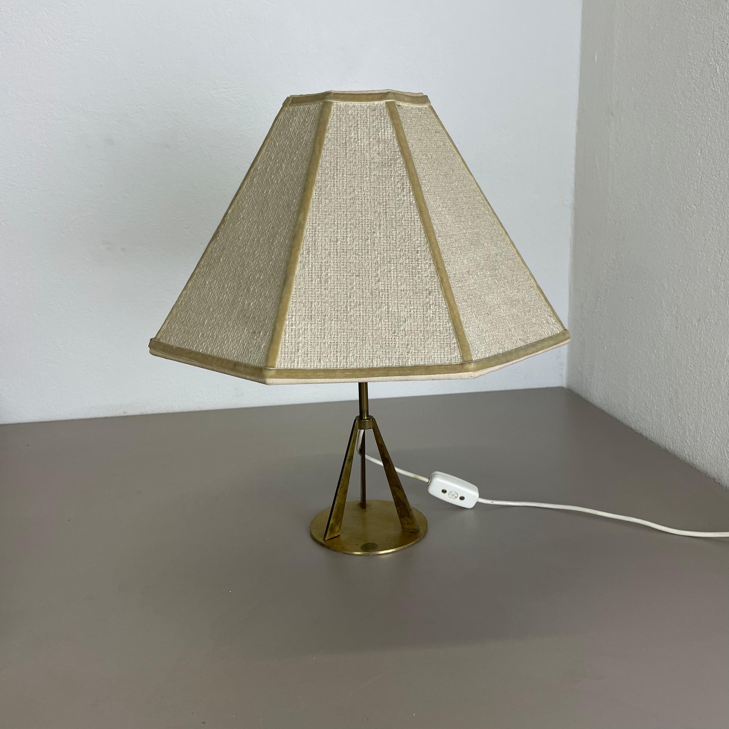 Article:

table light


Origin:

Austria


Age:

1960s


This original vintage table light was designed and produced in the 1960s in Austria. the super rare and minimalist stand element is made of brass combined with 3 upright standing metal parts