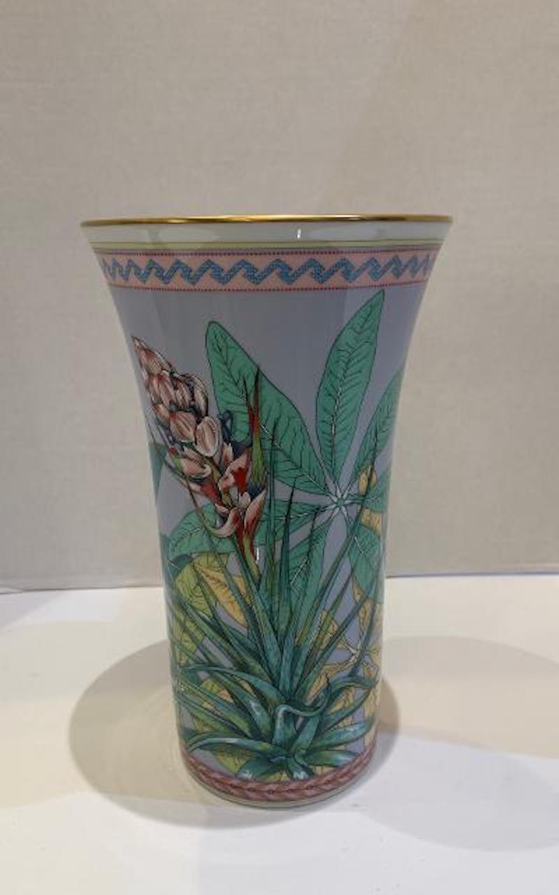Featuring a tropical and exotic paradise motif on a lavender background, this beautiful Rosenthal Versace vase is called 