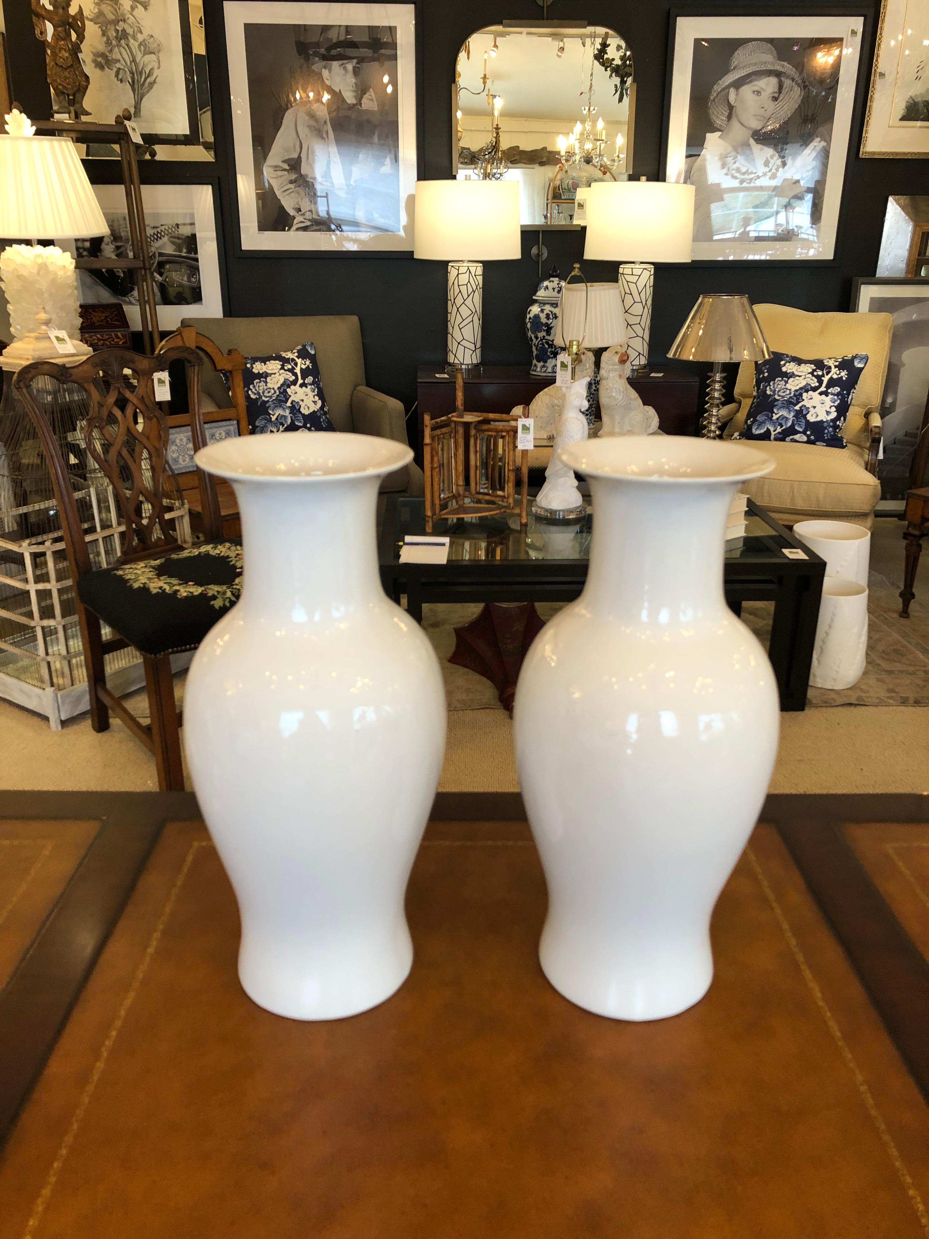 A versatile lovely pair of white blanc de chine Chinese vases that add beauty to any style room. 5.5 diameter opening.