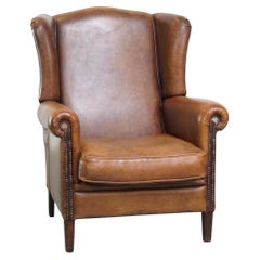 Bellissima, comodissima, sedia ad ala in pelle di pecora color cognac
