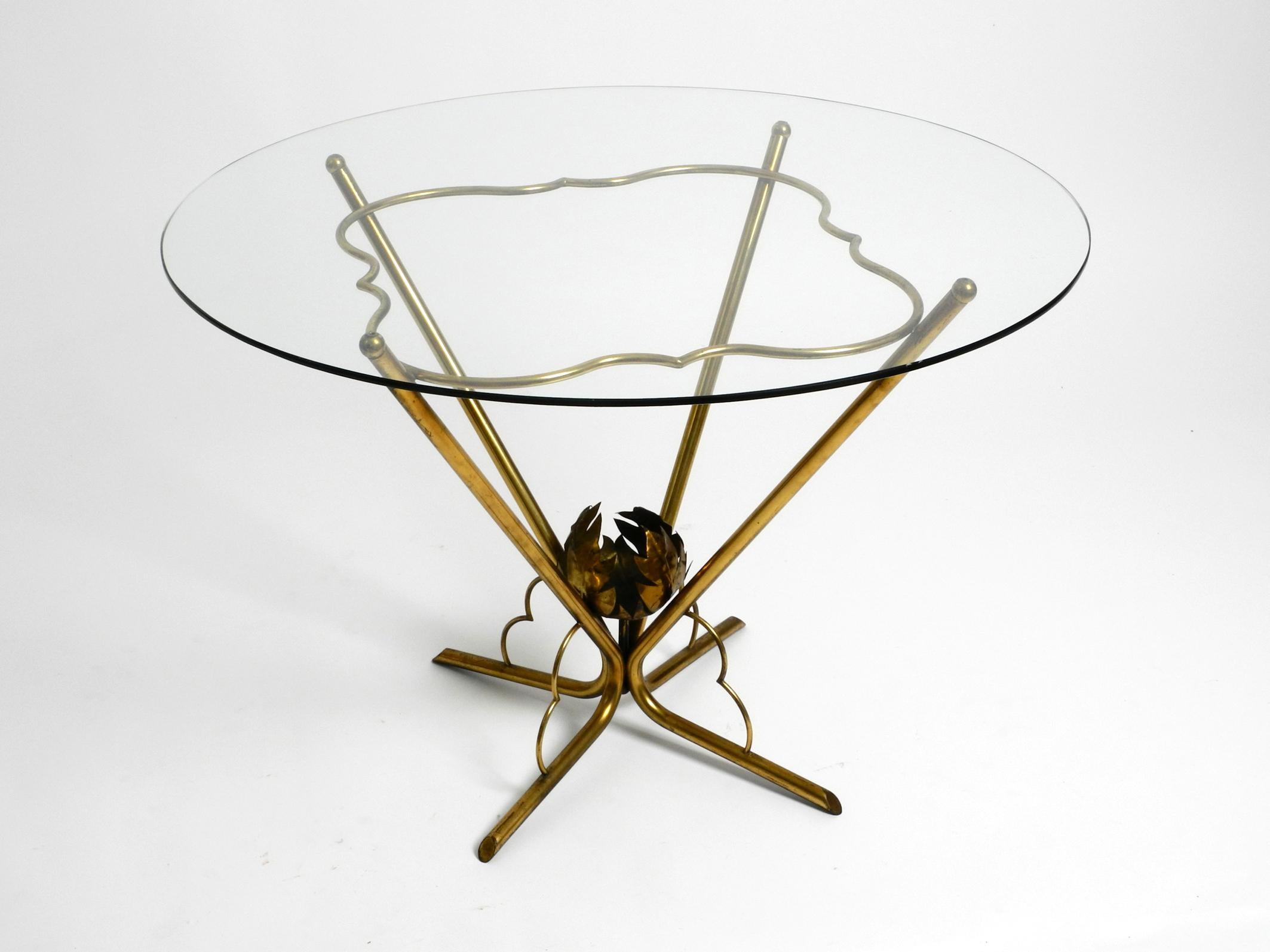 Very rare Italian original Mid Century Modern round glass brass side table.
Beautiful floral 1950s Italy design in very good vintage condition.
Four-legged frame made entirely of tubular brass in a curved shape.
Original round cut glass plate.
There