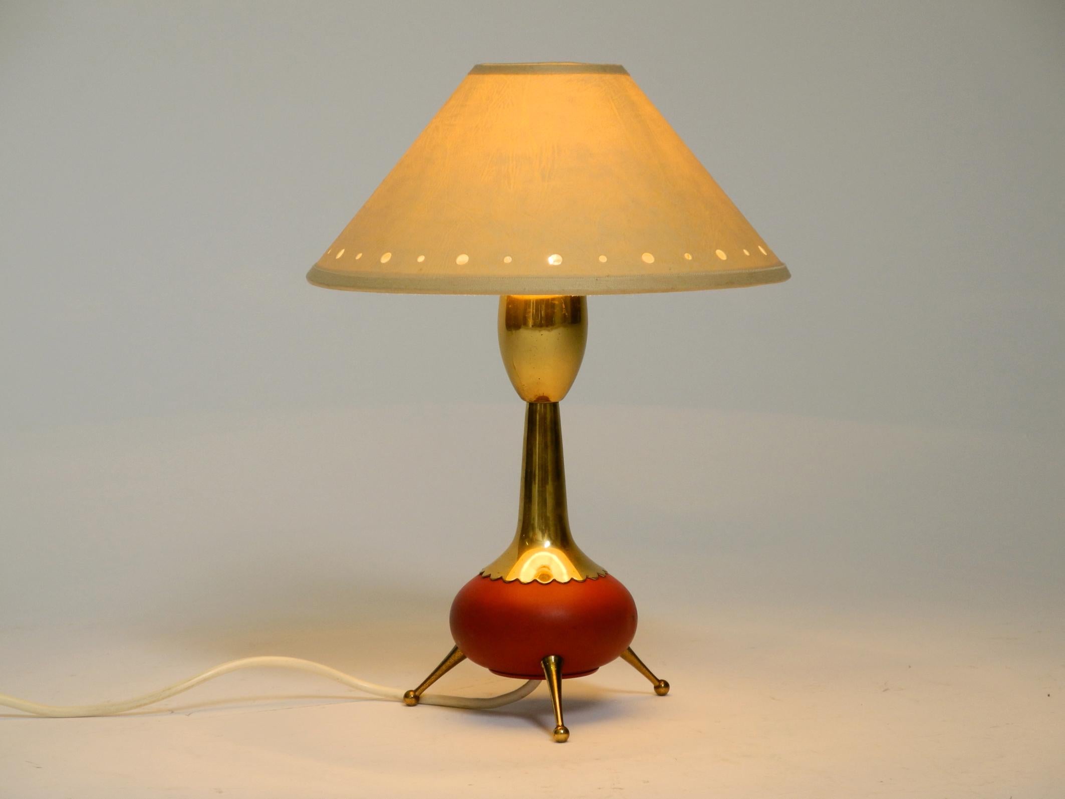 Beautiful rare original Mid Century Modern brass tripod table lamp with fabric lampshade.
Typical 1950s high quality design made of brass and red painted metal.
Very good vintage condition and fully functional.
No damage, only slight signs of