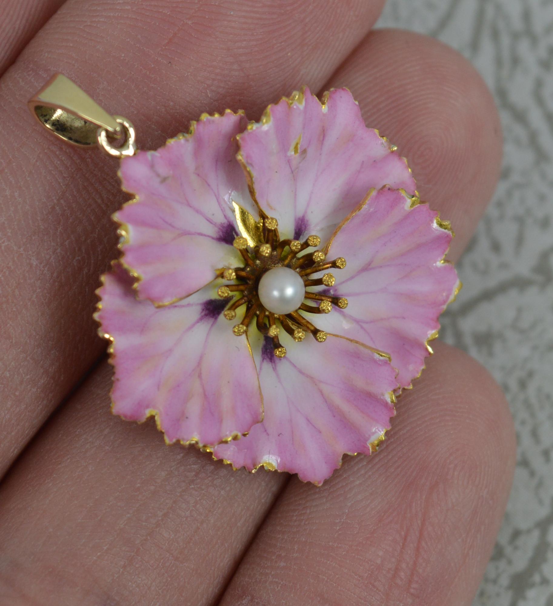 A superb Victorian era flower shape pendant, circa 1880.
Solid 14 carat gold example.
Designed with a pearl to centre and baby pink enamel to the front.

CONDITION ; Good for age. Crisp design. Well set pearl. Some wear and loss to enamelled front.