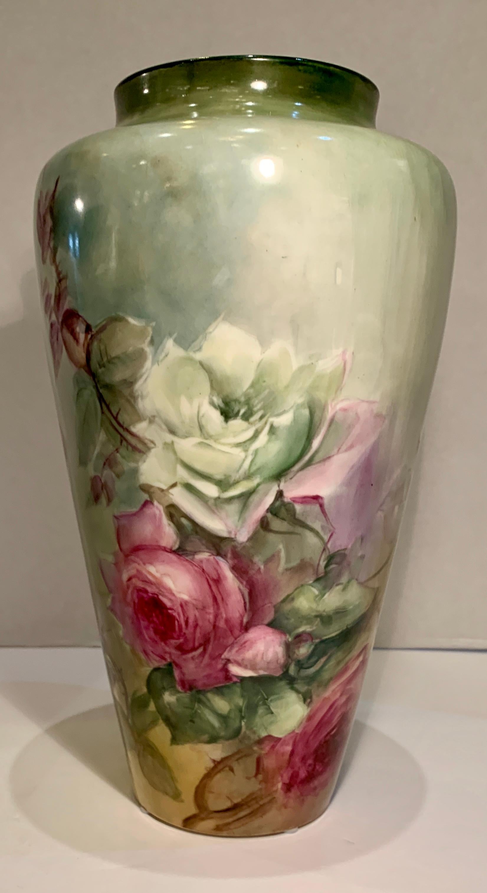 Exquisitely handmade and hand painted, turn of the century Victorian era antique porcelain vase features gorgeous, larger-than-life roses in full bloom, rosebuds and leaves, rendered in the naturalistic floral style popular in late nineteenth and