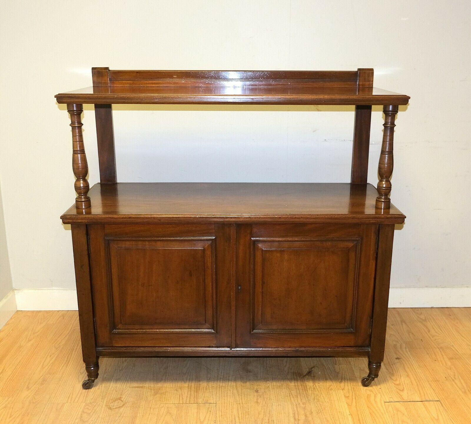 We are delighted to offer for sale this charming brown Mahogany Victorian Whatnot cupboard on castors.

This attractive and solid piece is well presented with an open upper tier and nice front supports and gallery edge top. The lower part opens to