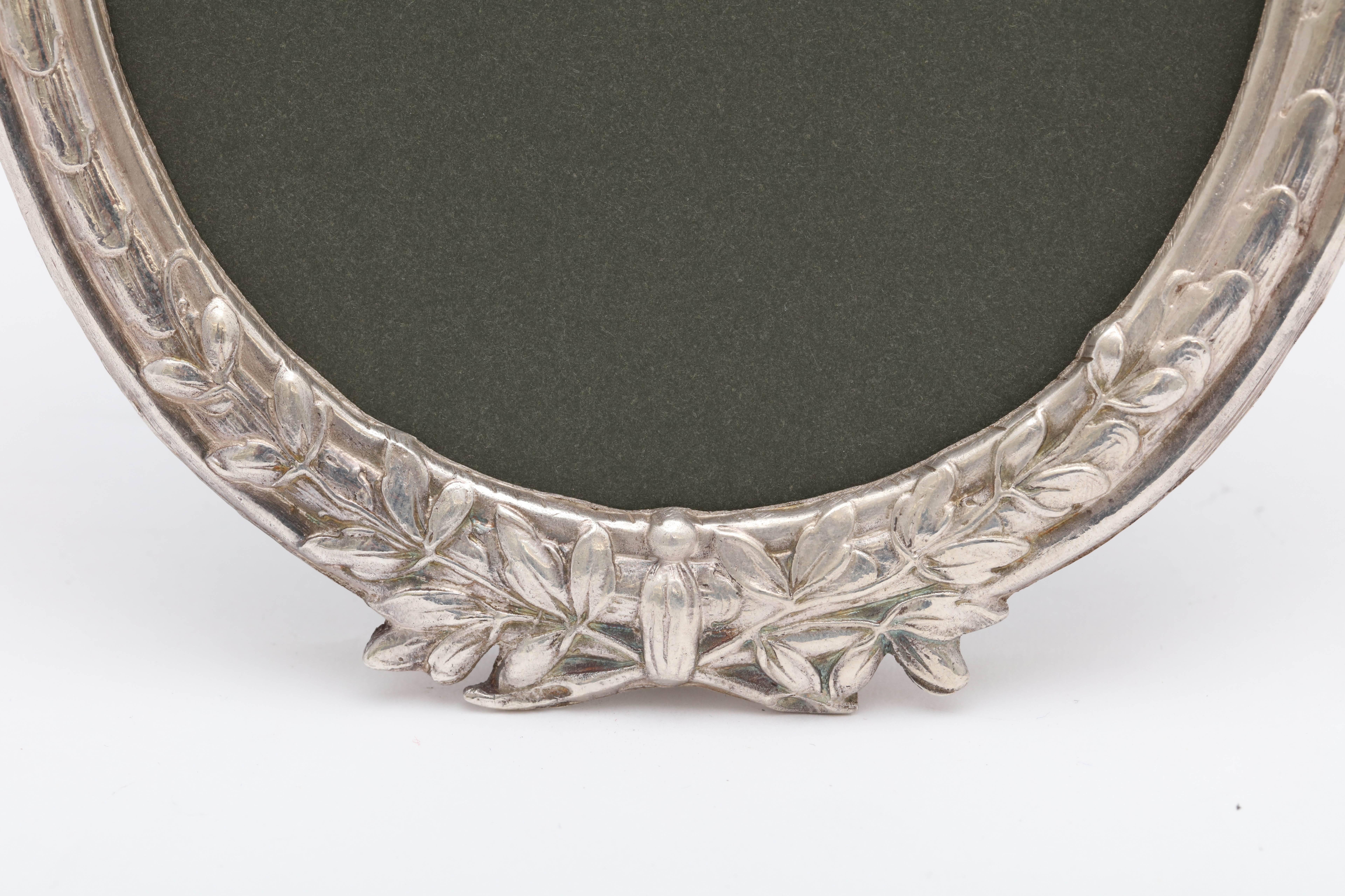 Beautiful, Victorian, continental silver (.800) oval picture frame with all silver easel, Germany, circa 1895, Hanau maker's marks. Measures: 8 inches high at highest point x over 4 1/2 inches wide at widest point x 4 3/4 inches deep when easel is