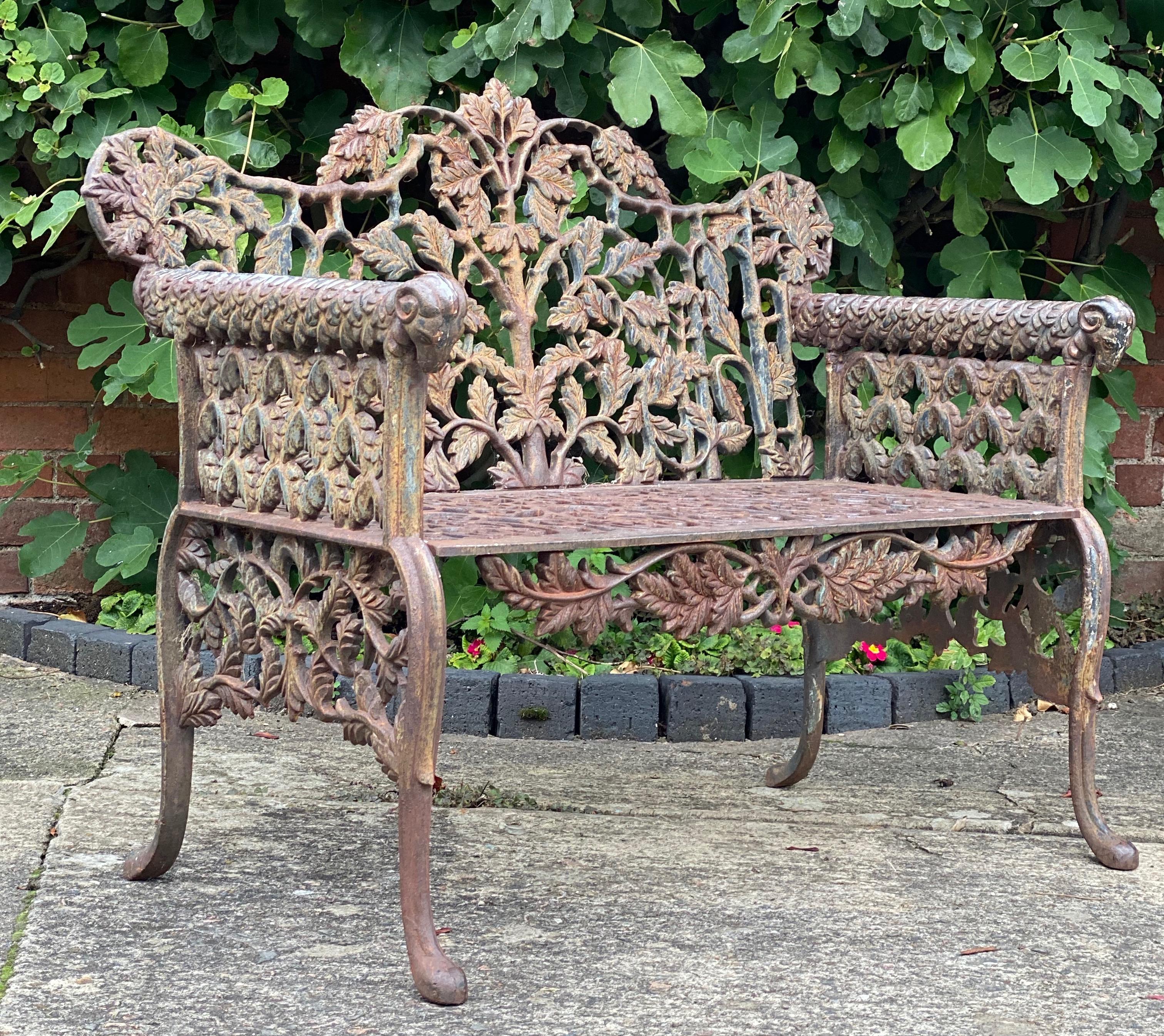 Beautiful Victorian style cast iron garden bench seat

Beautiful heavy Victorian style cast iron garden bench, arms terminating with rams heads with oak leaf pattern to back with gothic style lattice work to sides, front apron with scrolling