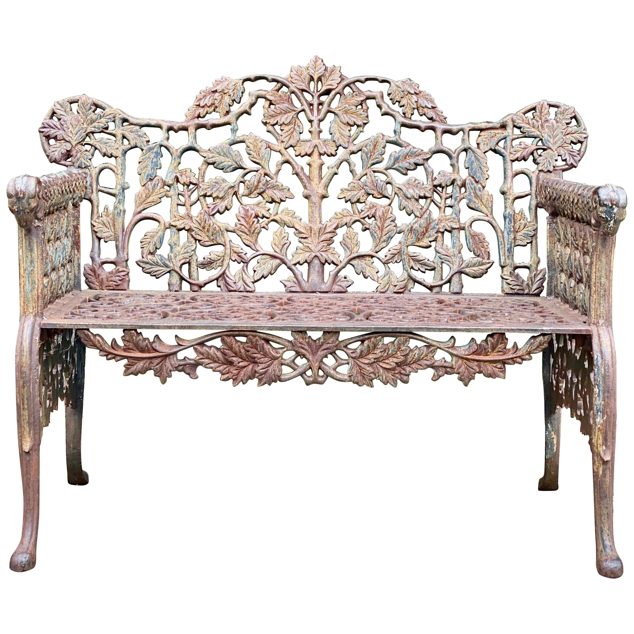 Beautiful Victorian style cast iron garden bench seat

Beautiful heavy Victorian style cast iron garden bench, arms terminating with rams heads with oak leaf pattern to back with gothic style lattice work to sides, front apron with scrolling
