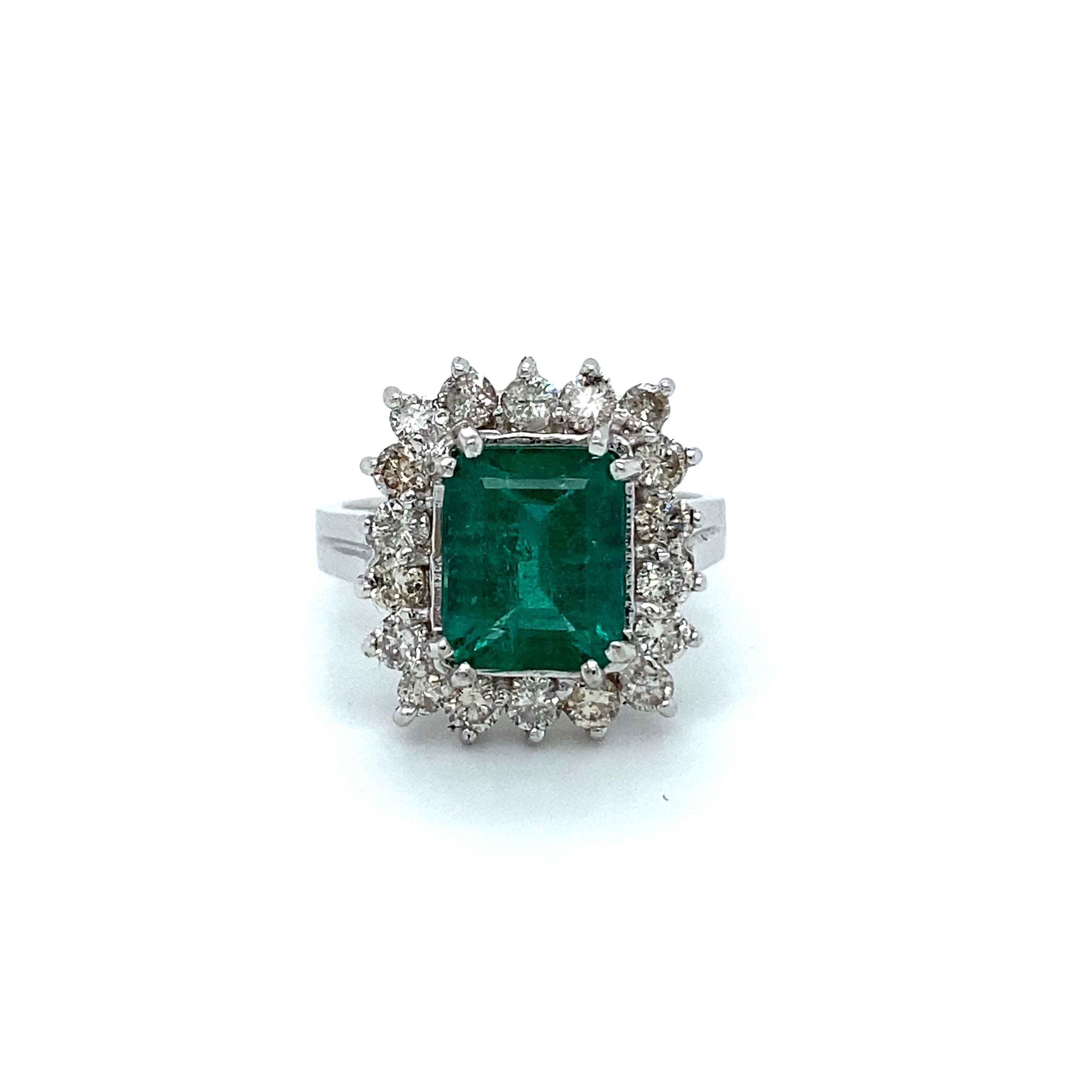 Whoa there gorgeous! This Beautiful Vintage Emerald and Diamond Cut Halo Ring is just stunning. Crafted in 14K White Gold, the ring is a classic halo design, with the shaping of the ring following the cut of center. In the center, the ring holds One