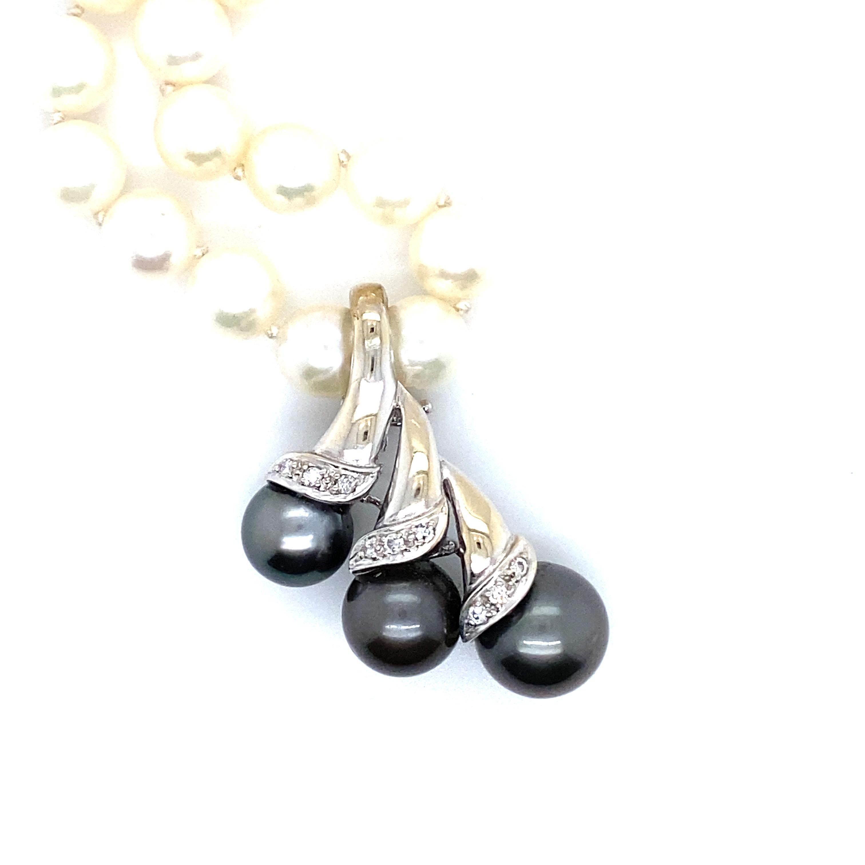 What a beautiful piece this is! I just love it! Crafted in 18K White Gold, the design features a spray of Black Tahitian Pearls, accented with diamonds. 
The three pearls are graduated in size, and range from 8.6mm to 10.3mm. In addition, there are