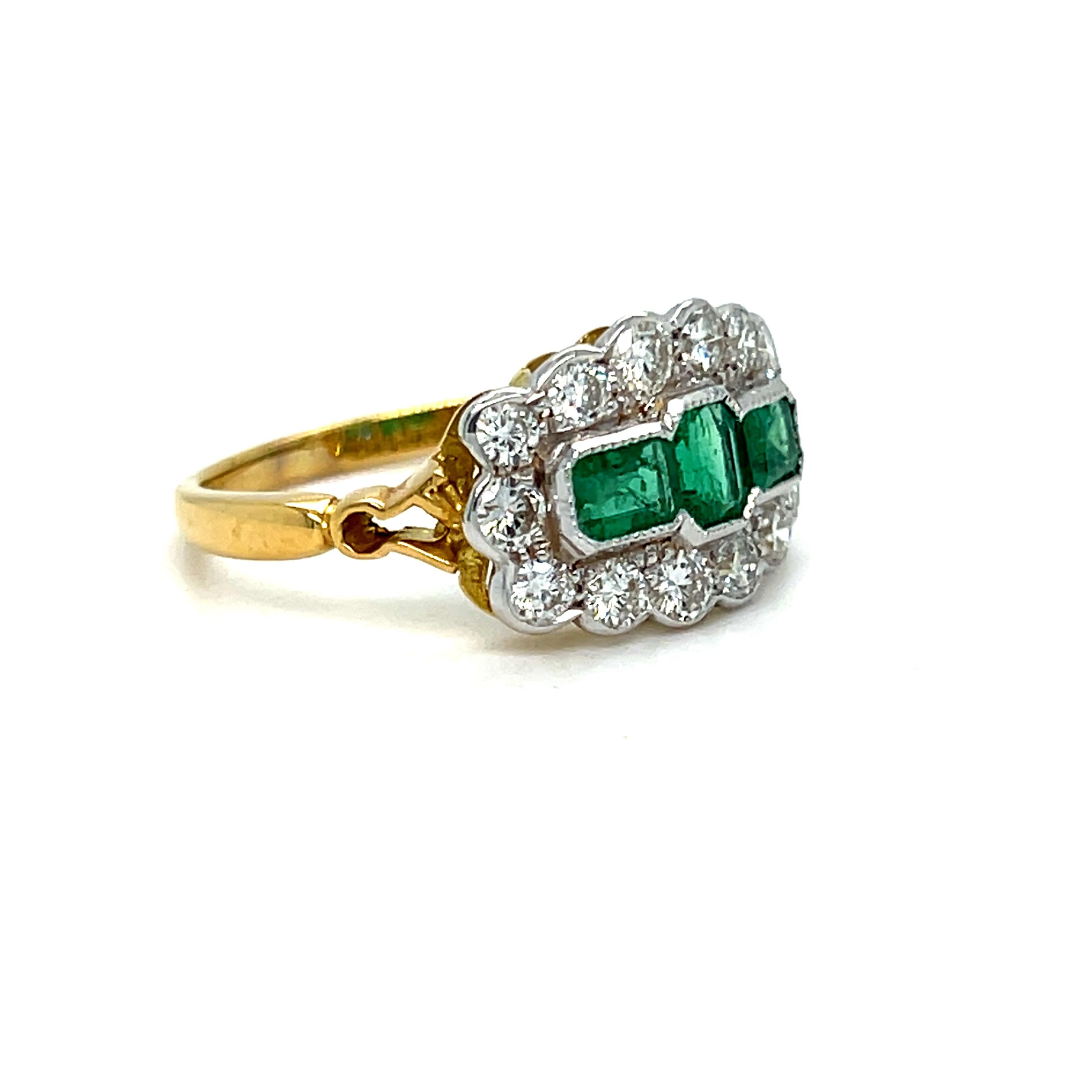 This Vintage Diamond and Emerald Ring is just beautiful! Crafted in 18K Yellow Gold, the ring is a classic design, with three gorgeous Natural Green Emeralds in the center,  surrounded by Round Brilliant Cut Diamonds, and detailed with beaded edges,