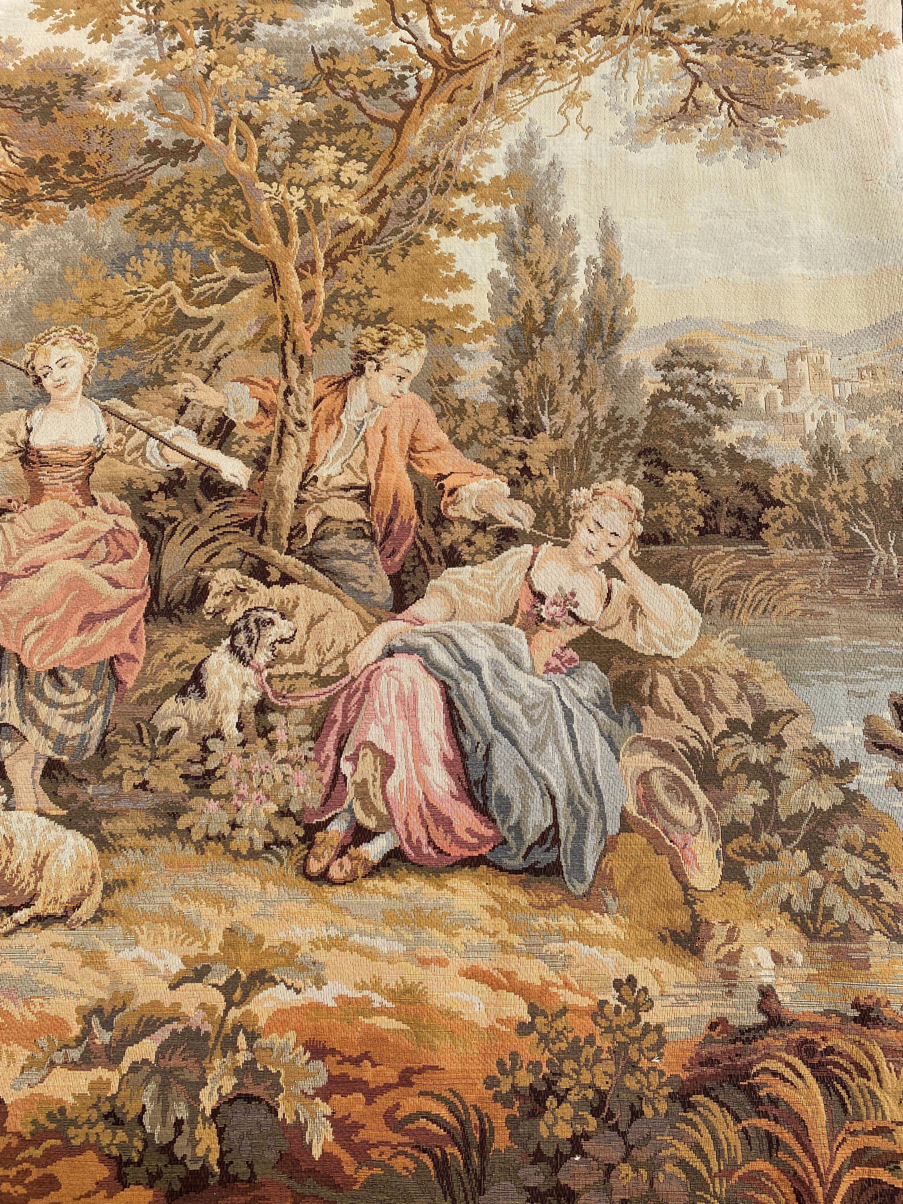 Introducing a magnificent 20th-century tapestry that captures the essence of the gentle joys of life, festivities, music, and above all, love. Set against a rustic backdrop, shepherds and shepherdesses embrace amid a serene landscape with a few