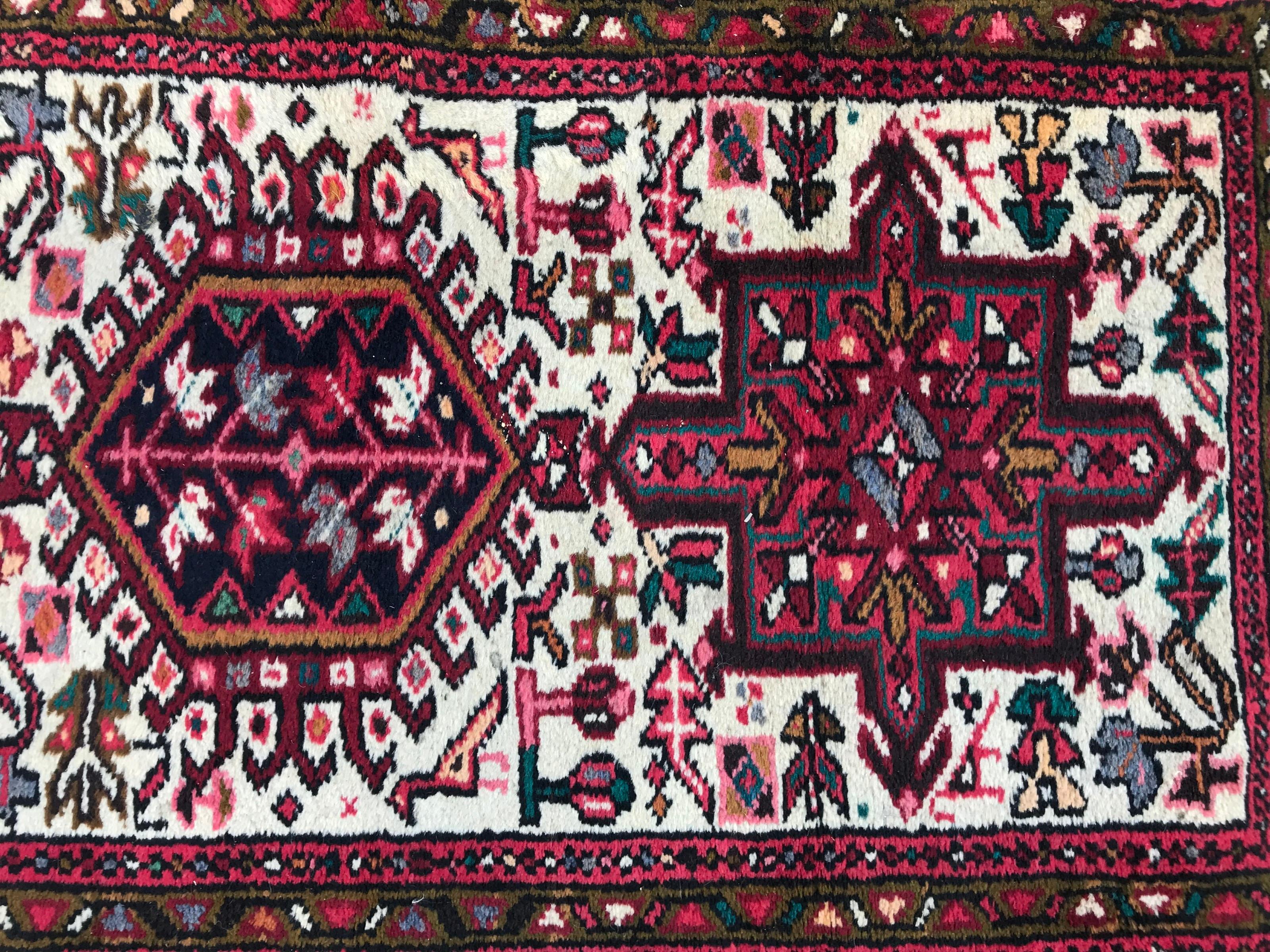 Nice 20th century runner with a geometrical Heriz style design and nice colors with white field, pink, purple, yellow, green and blue, entirely hand knotted with wool velvet on cotton foundation.