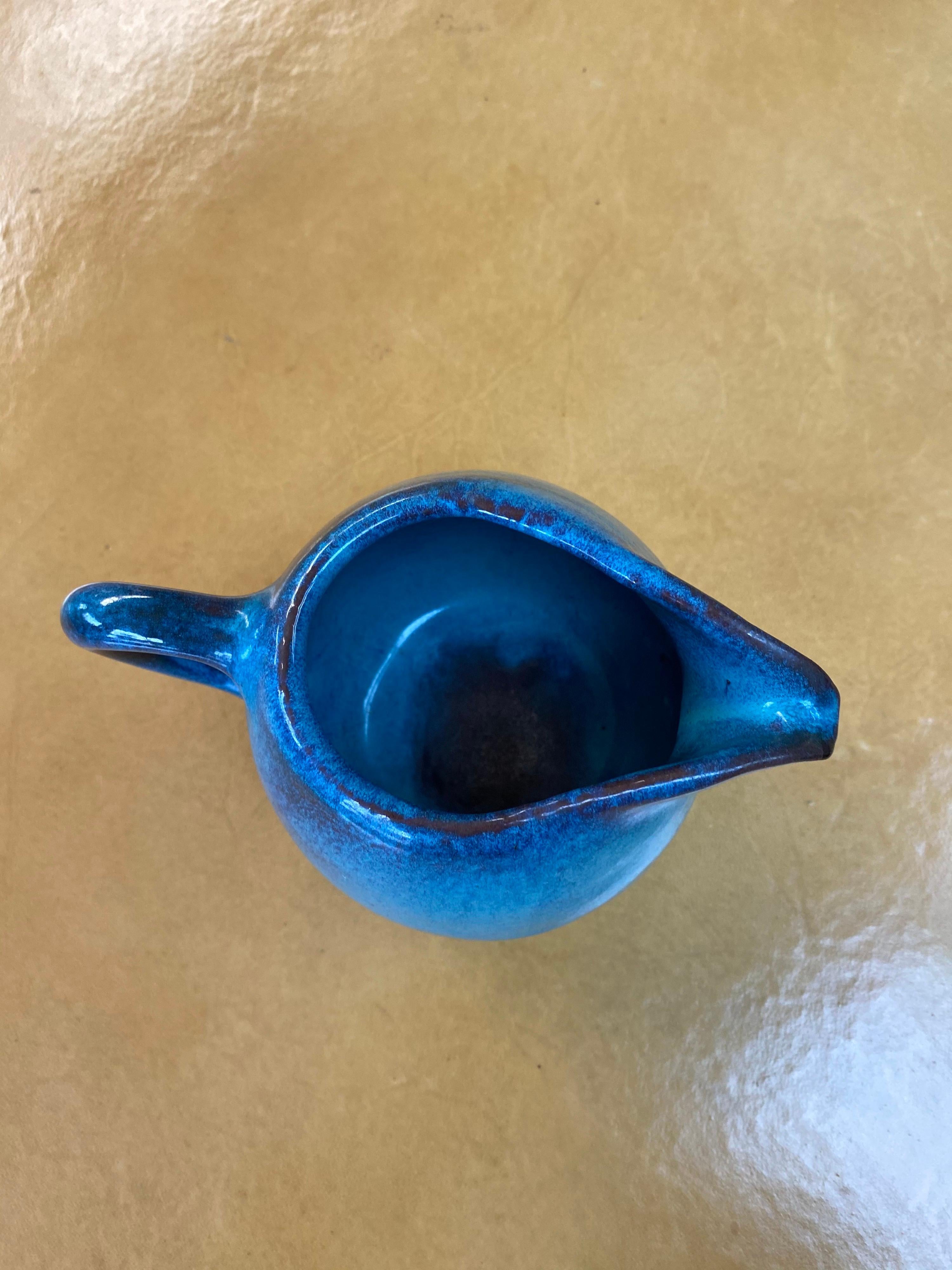 Mid-Century Modern glazed ceramic pitcher by ceramicist Harding Black signed and dated 1971. This ceramic pitcher features a vibrant blue and combination glaze and is in great vintage condition.