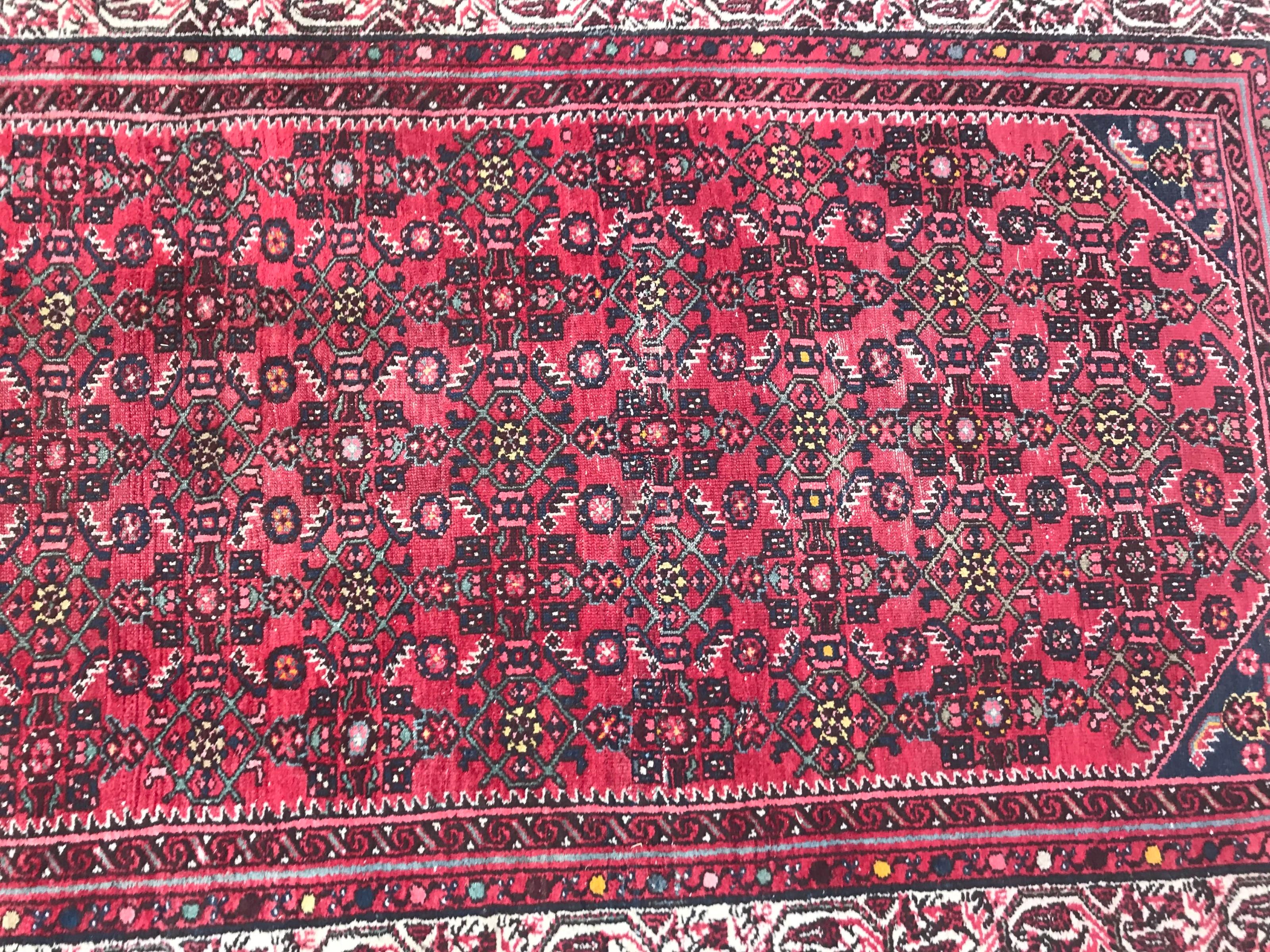 Beautiful mid-20th century runner with a beautiful Herati design with red field, blue, green, yellow and pink colors, entirely hand knotted with wool velvet on cotton foundation.