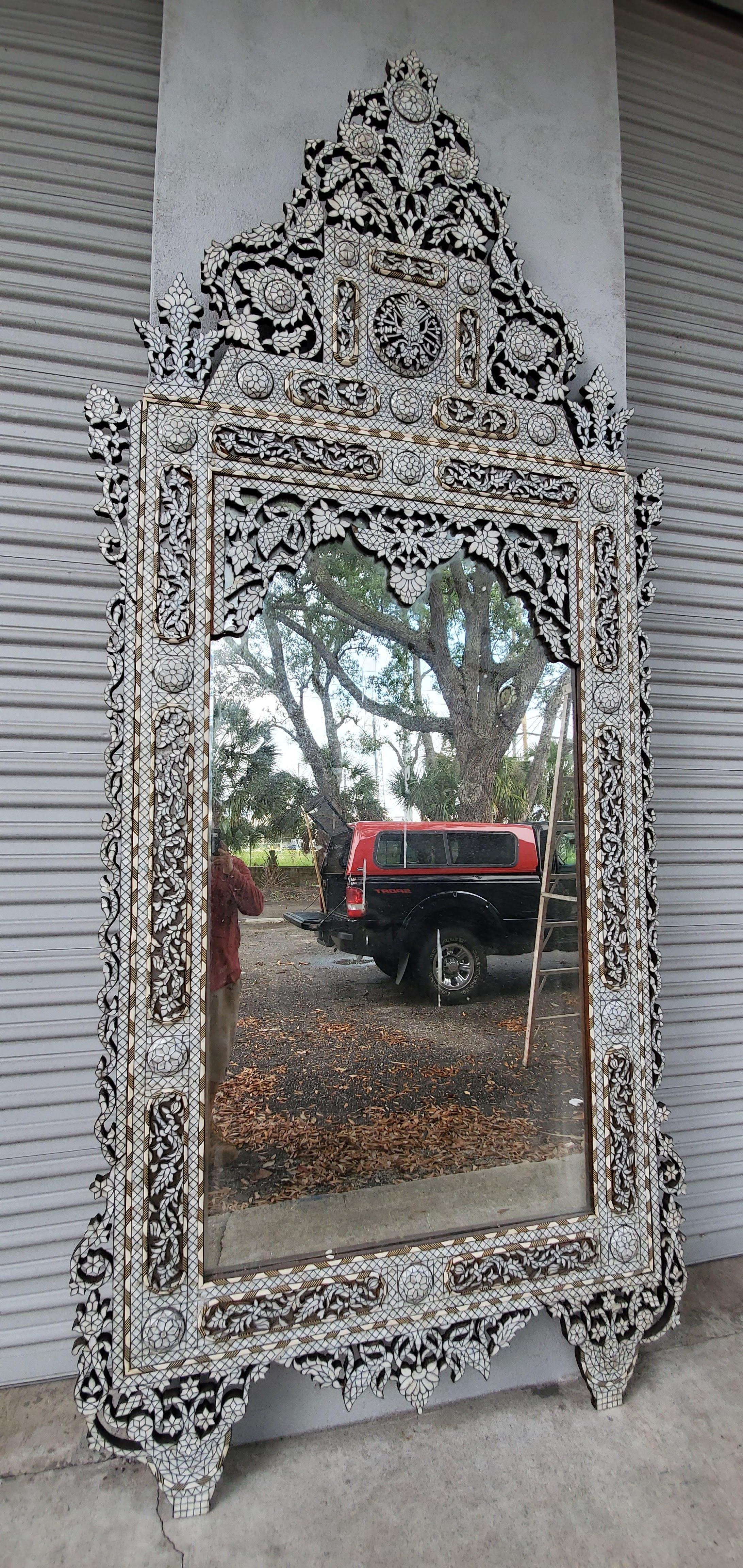 This antique handcrafted inlaid mirror is crafted from individuality cut pieces of mother of pearl and camel bone. The high bonnet top is geometric style design is detachable for easy transport.
Details.