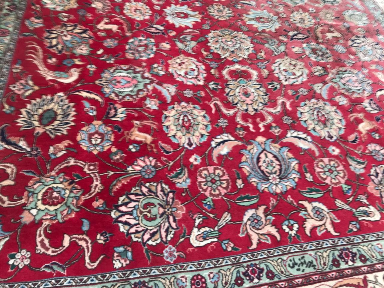 Very beautiful large rug with a nice decorative design and red field color with green, orange and blue. Entirely hand knotted with wool velvet on cotton foundation.