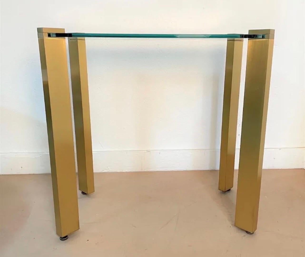 A beautiful vintage Mid-Century Modern brass with thick glass top inset to each leg, console / serving table.
Minor wear from age & regular use.