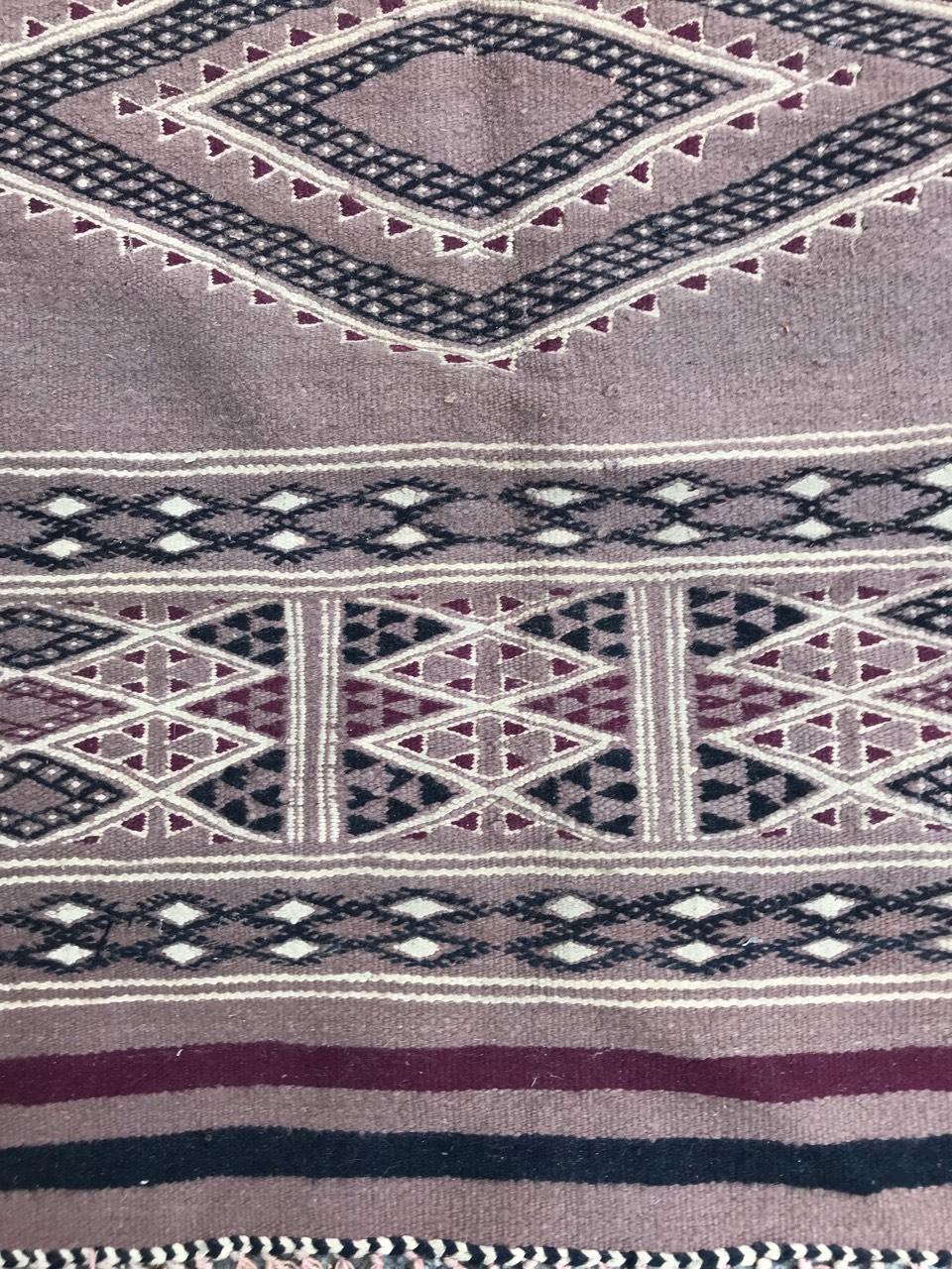 Nice 20th century Moroccan Kilim with a beautiful geometrical tribal design a pink field color, entirely handwoven with wool on cotton foundation.