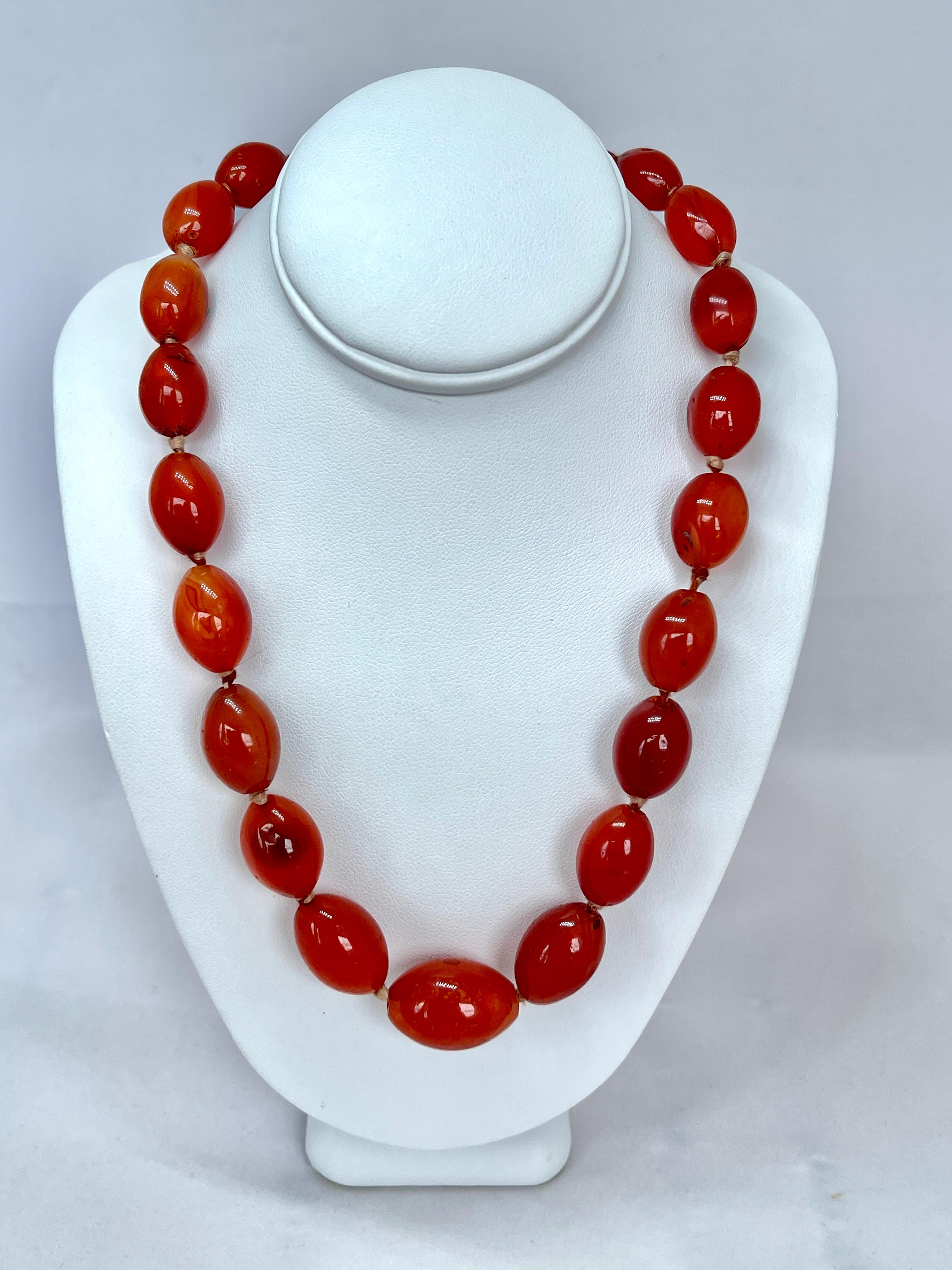 This vintage necklace features natural Carnelian, oval shaped beads.  They vary in size from the front to the back and are individually knotted.  

Each bead has been honed by hand and retain some of the natural inclusions of genuine earth mined