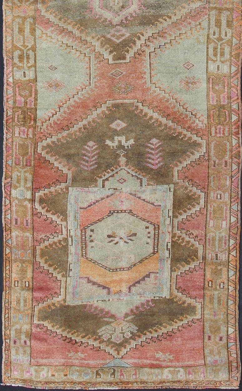 Turkish tribal design colorful gallery runner in soft tones, rug en-176022, country of origin / type: Turkey / Oushak, circa 1940

This expansive Gallery rug from Turkey features a colorful pattern of unique tribal medallion designs, surrounded