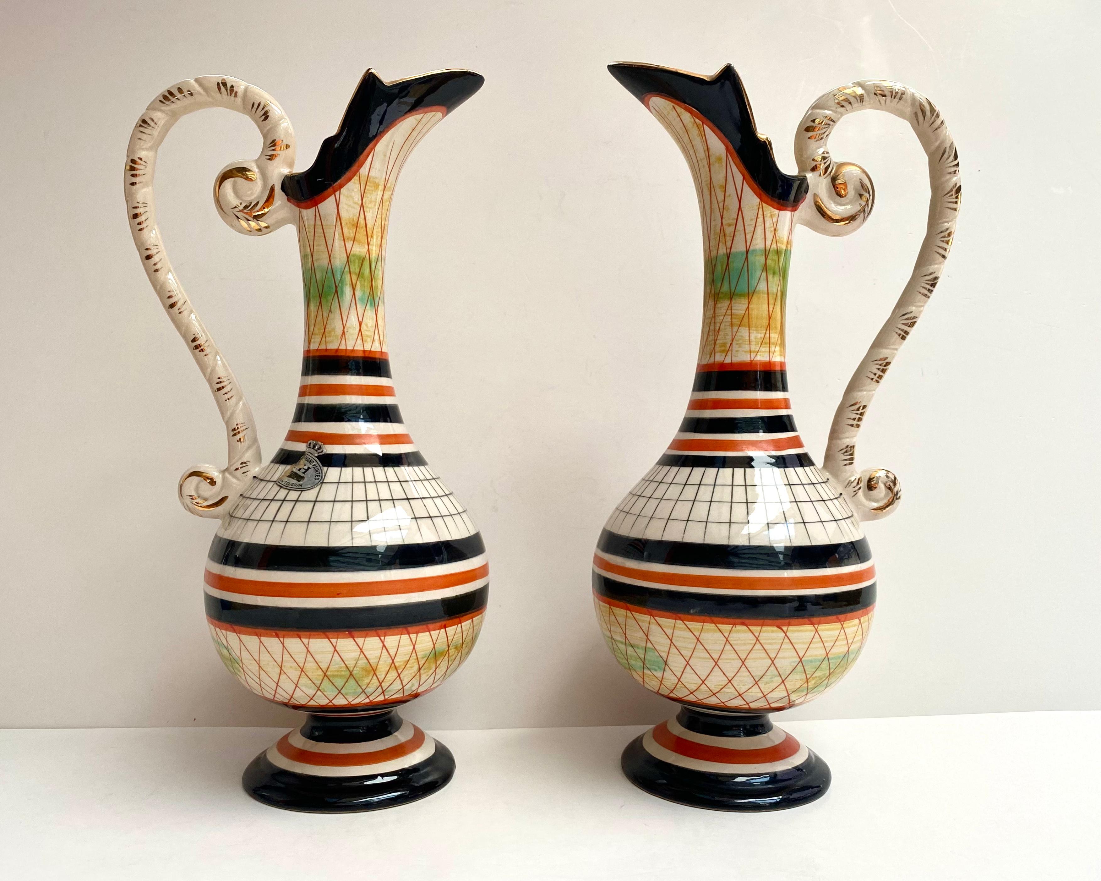 Very beautiful Art Deco ceramic vases/pitchers with handle. Set 2. Hubert Bequet. Belgium. 1970s.

Beautiful ceramic vase, hand-painted with geometric patterns and gilding from Quaregnon in Belgium, signed Hubert Bequet.

Marked 272 On the