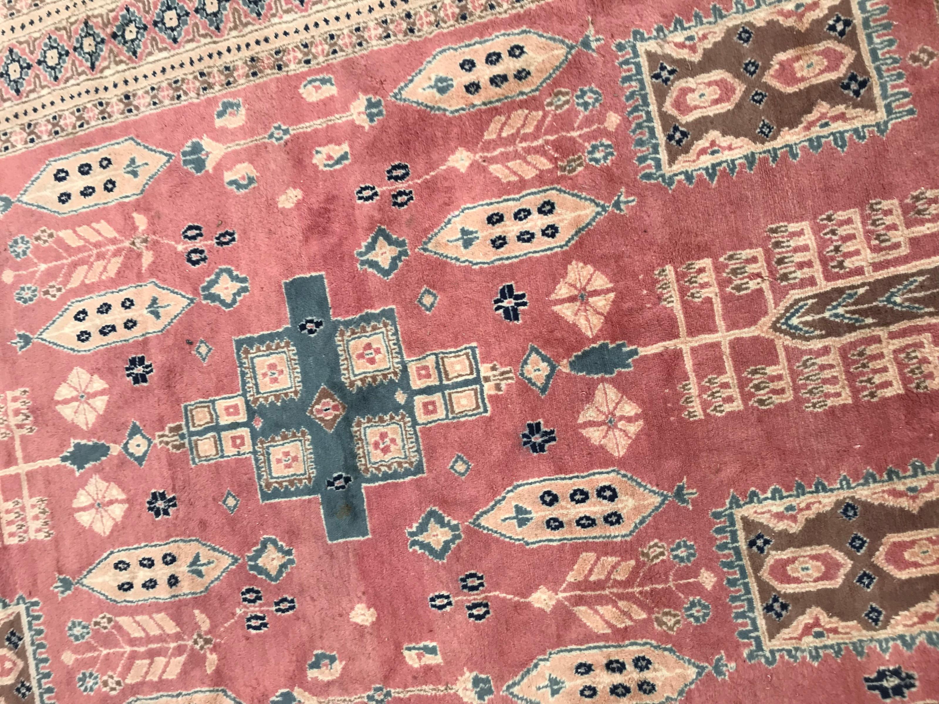 20th century decorative rug from Pakistan with a beautiful design and a pink field colors, entirely hand knotted with wool velvet on cotton foundation.