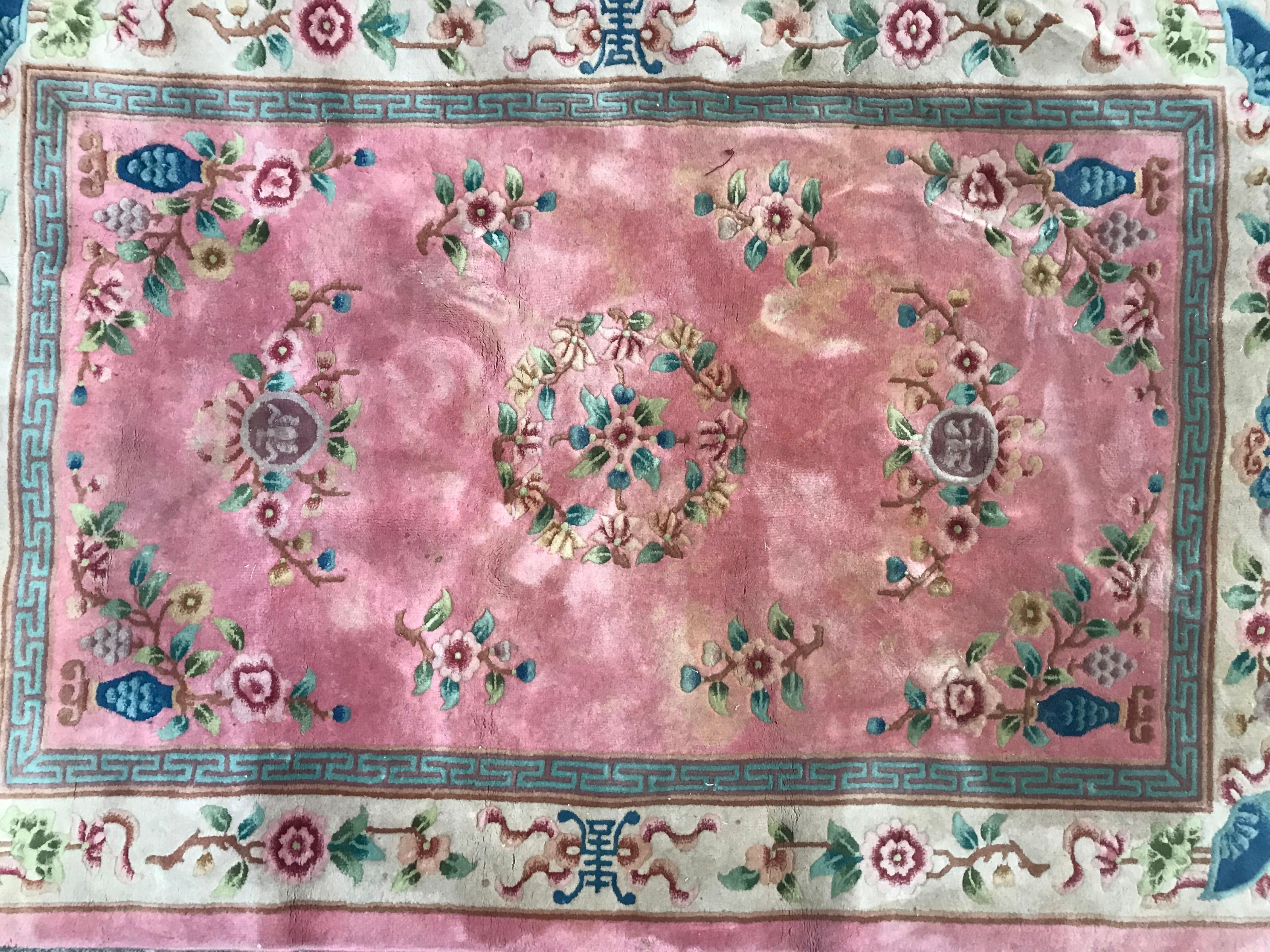 Nice 20th century Chinese rug with Chinese design and beautiful colors with pink, blue, yellow and green, entirely hand knotted with wool velvet on cotton foundations.