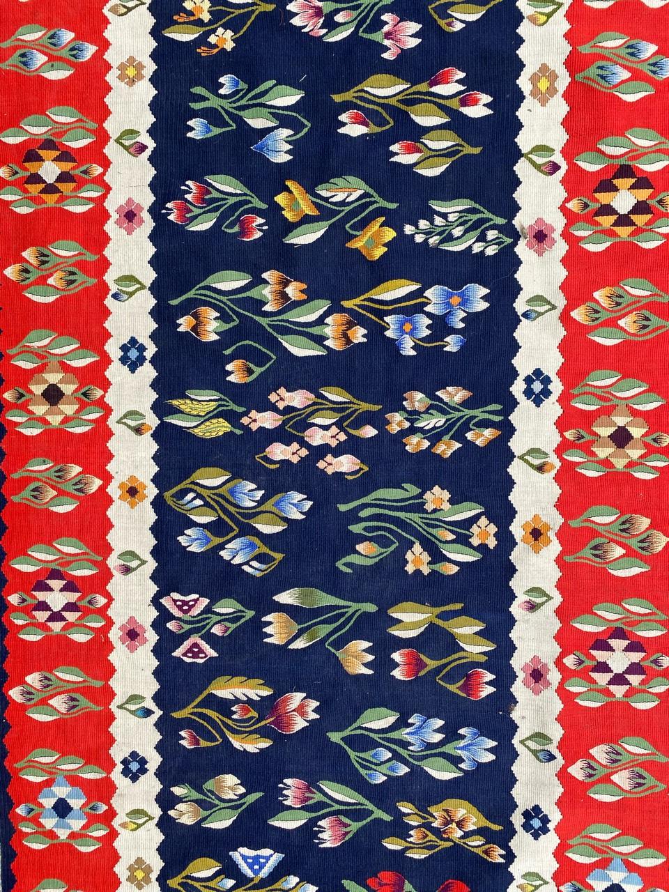 Very beautiful midcentury Kilim with nice floral design and beautiful colors with red, blue, yellow, purple and green, entirely handwoven with wool on cotton.