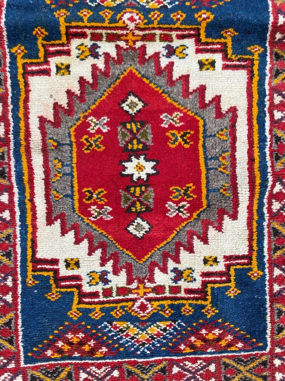 Very beautiful little Moroccan rug with a geometrical design and nice colors with orange, blue, red, yellow, grey and black, entirely hand knotted with wool velvet on wool foundation.