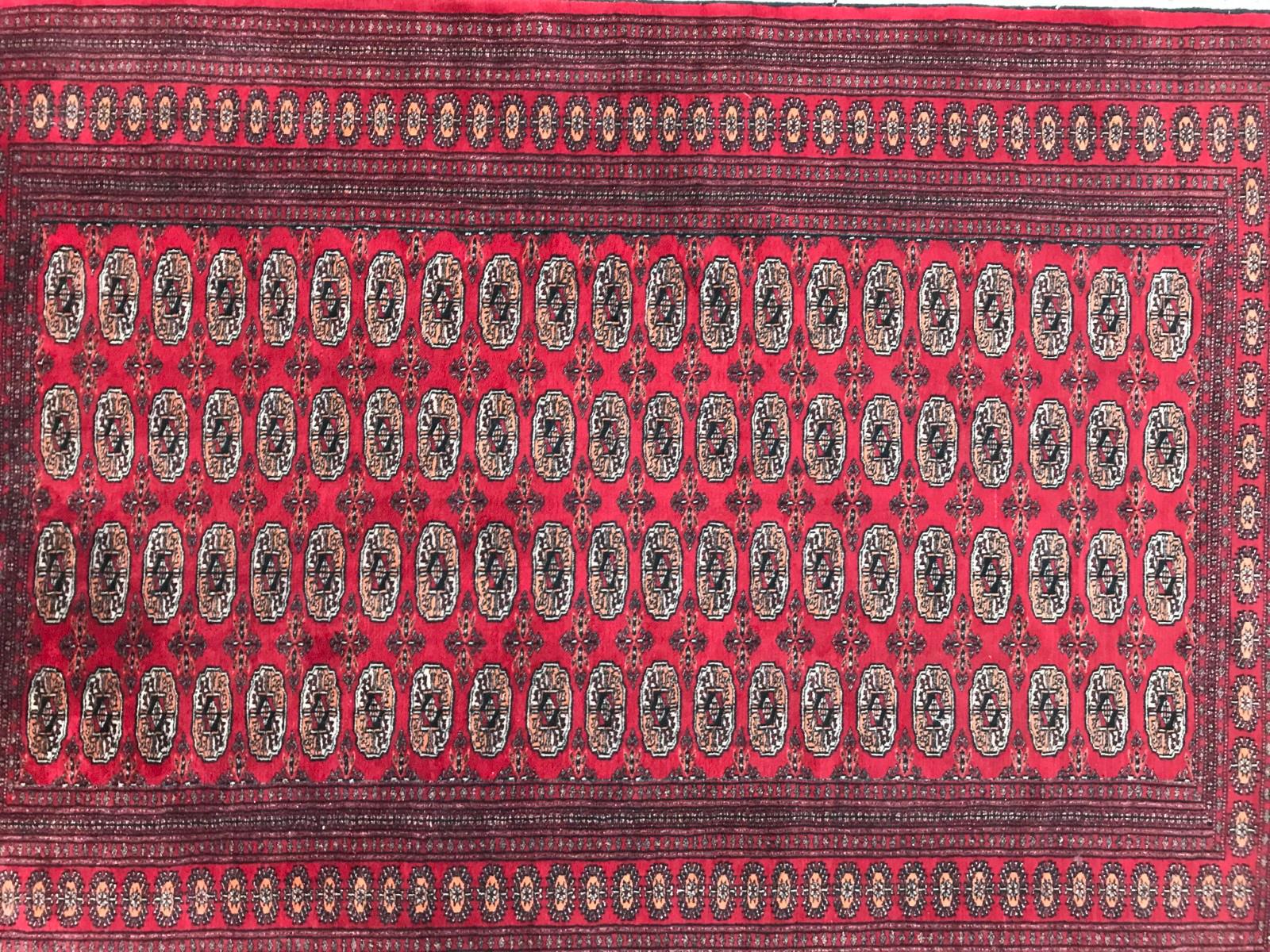 A red field Boukhara design rug, beautiful geometrical design, and nice colors, entirely hand knotted with wool velvet on cotton foundation.