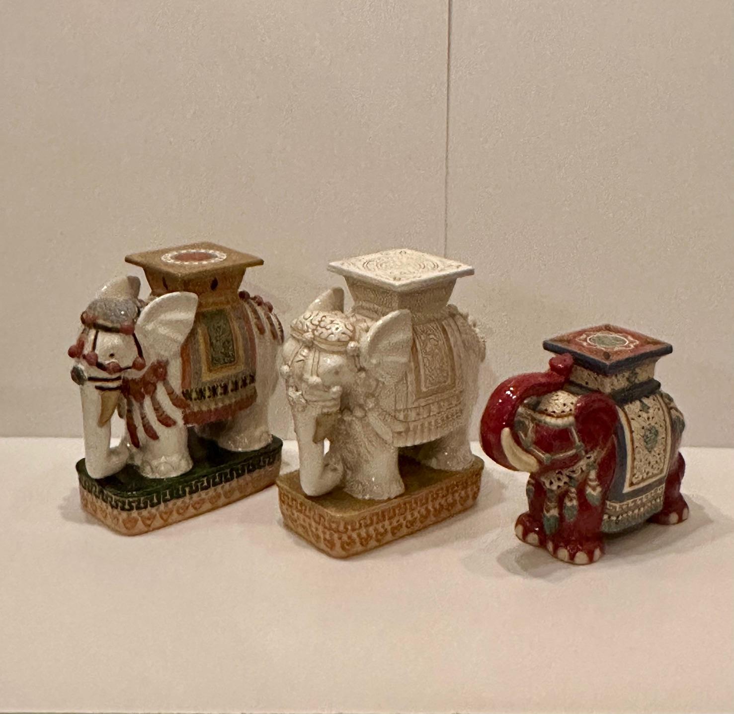 Beautiful mid 20th century glazed terracotta side or drinks table garden seat in the shape of an elephant. Colors are white with multi colored saddle.  Note: We have two other elephant garden seats as shown in photos if you are looking for a pair or
