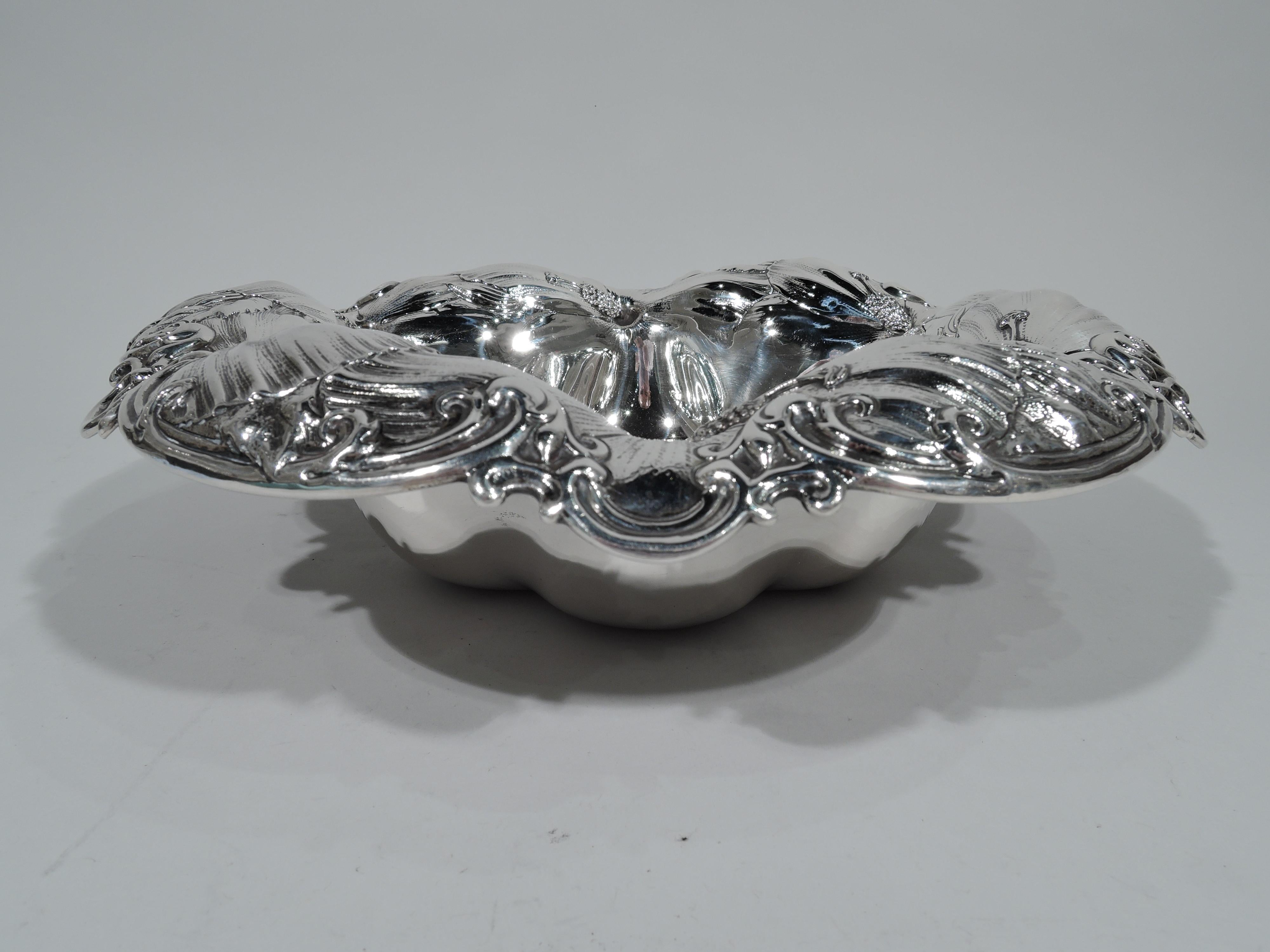 Beautiful Art Nouveau sterling silver bowl. Made by Whiting in New York, circa 1910. Lobed well and wide, wavy, and curved rim with chased scrolls and overlapping blooms. Turn-of-the-century floral exuberance. Hallmark includes no. 6072. Weight: 22