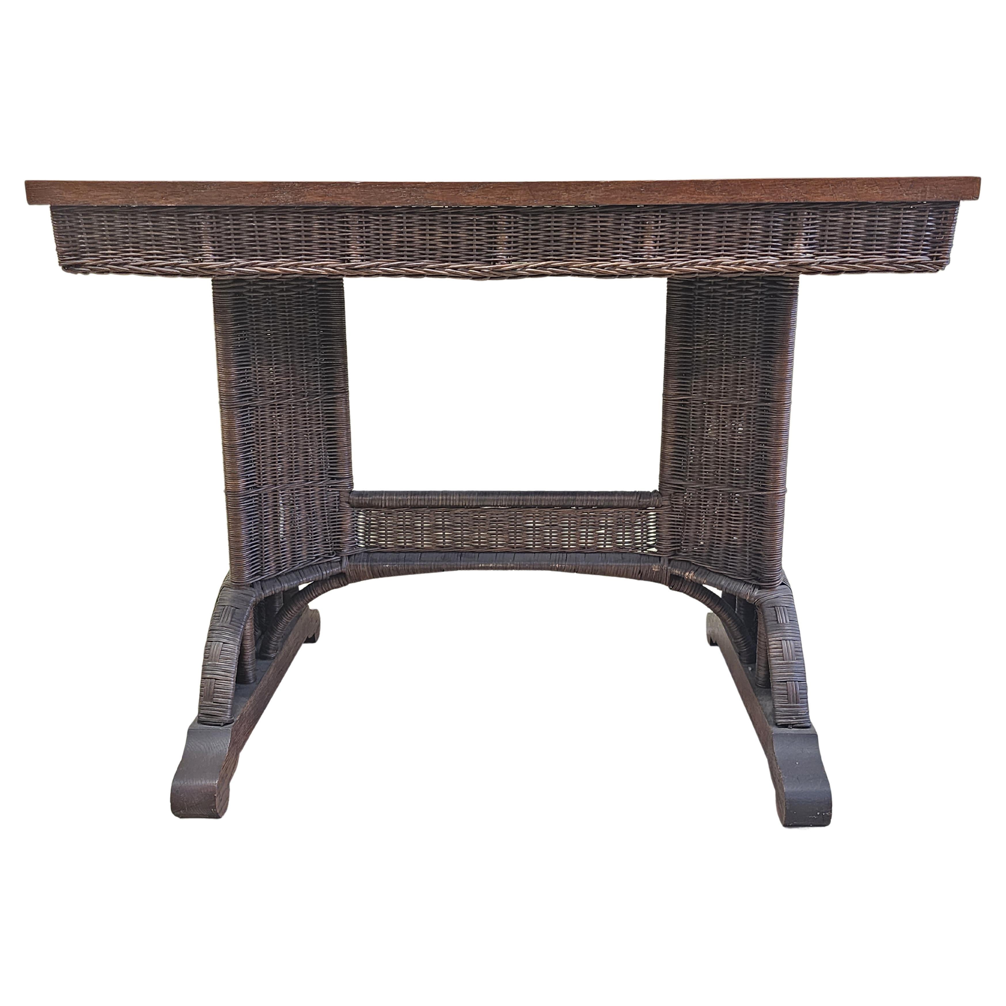 This is an exceptional Hayward Brothers wicker table with quartersawn oak top. Circa 1900 and an excellent original condition. Architecturally and detail-wise this is top of the line. Would make an excellent desk center table or hall table.