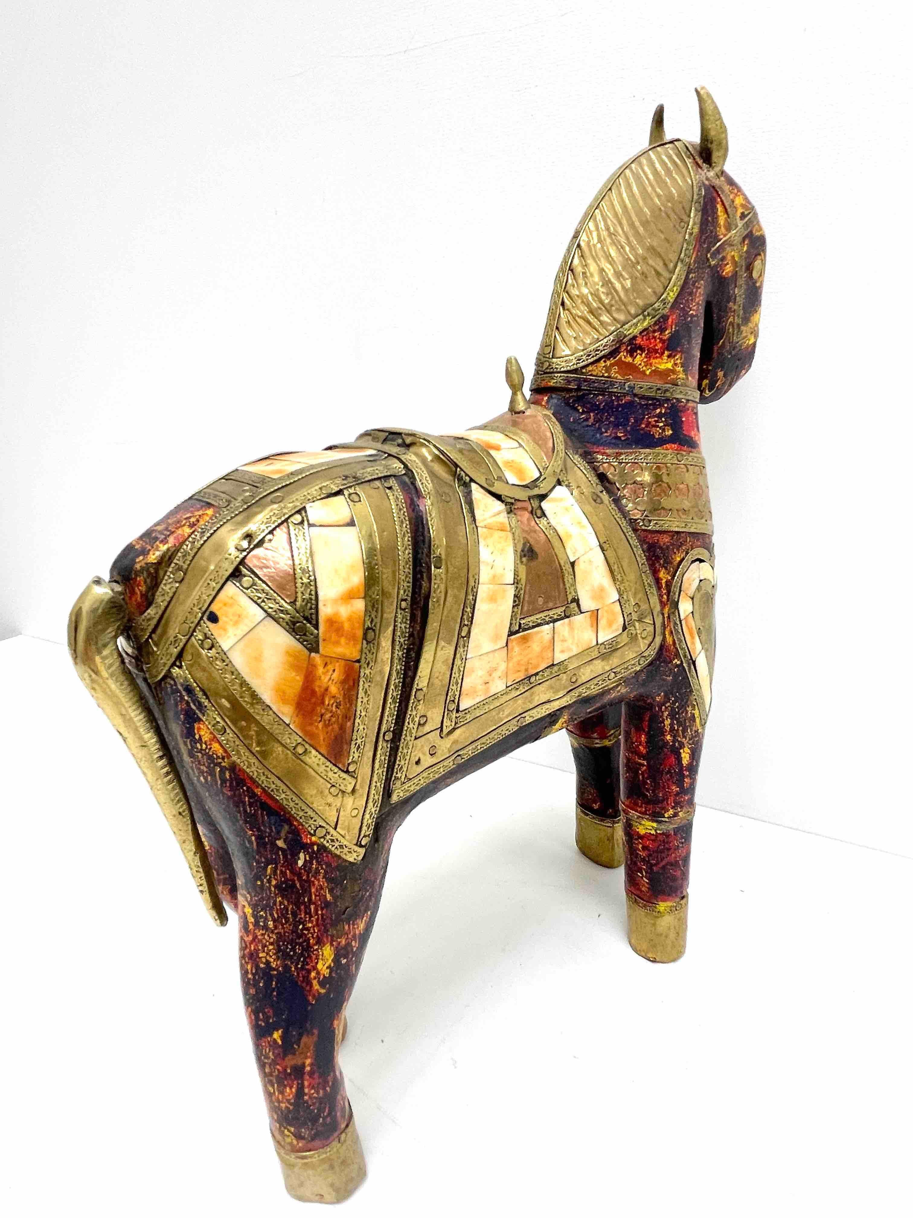 A beautiful decorative horse statue. Some wear with a nice patina, but this is old-age. Wooden horse colored in red, with some metal and stone parts. Very decorative and nice to display in your library or any room.