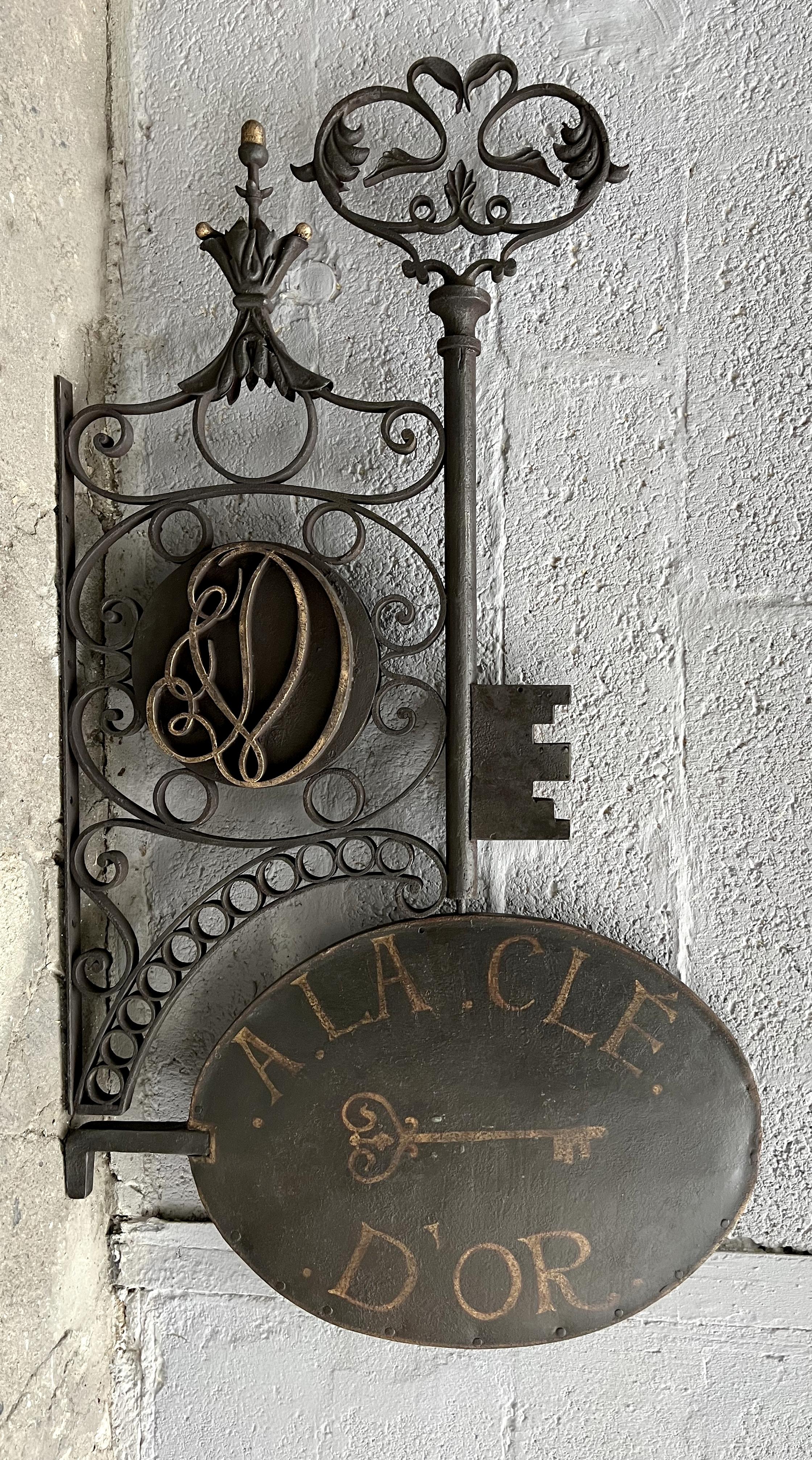 Beautiful wrought-iron locksmith's sign, hand-crafted in France on the first part of the 19th century. It's entirely double-sided, in finely worked wrought iron. The part under the key bears forged initials and the sign itself, in shaped sheet iron,