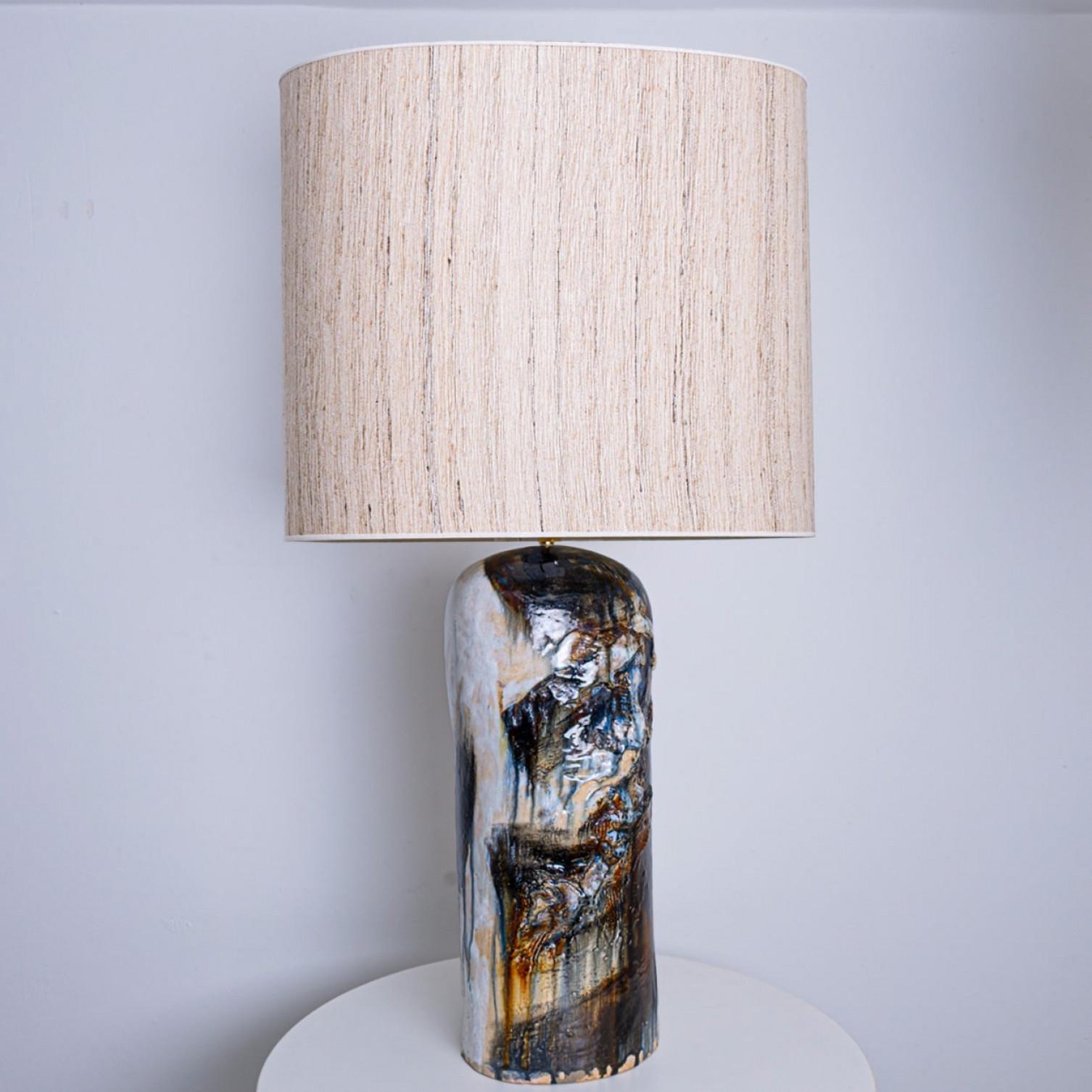 Beautiful floor table lamp by Jeppe Hagendorn, Denmark 1960s.

This stunning lamp has a ceramic base with earthy and blue tones and a beautiful glaze, making it a real eye catcher and a statement piece. The lampshade is designed by Rene Houben. This