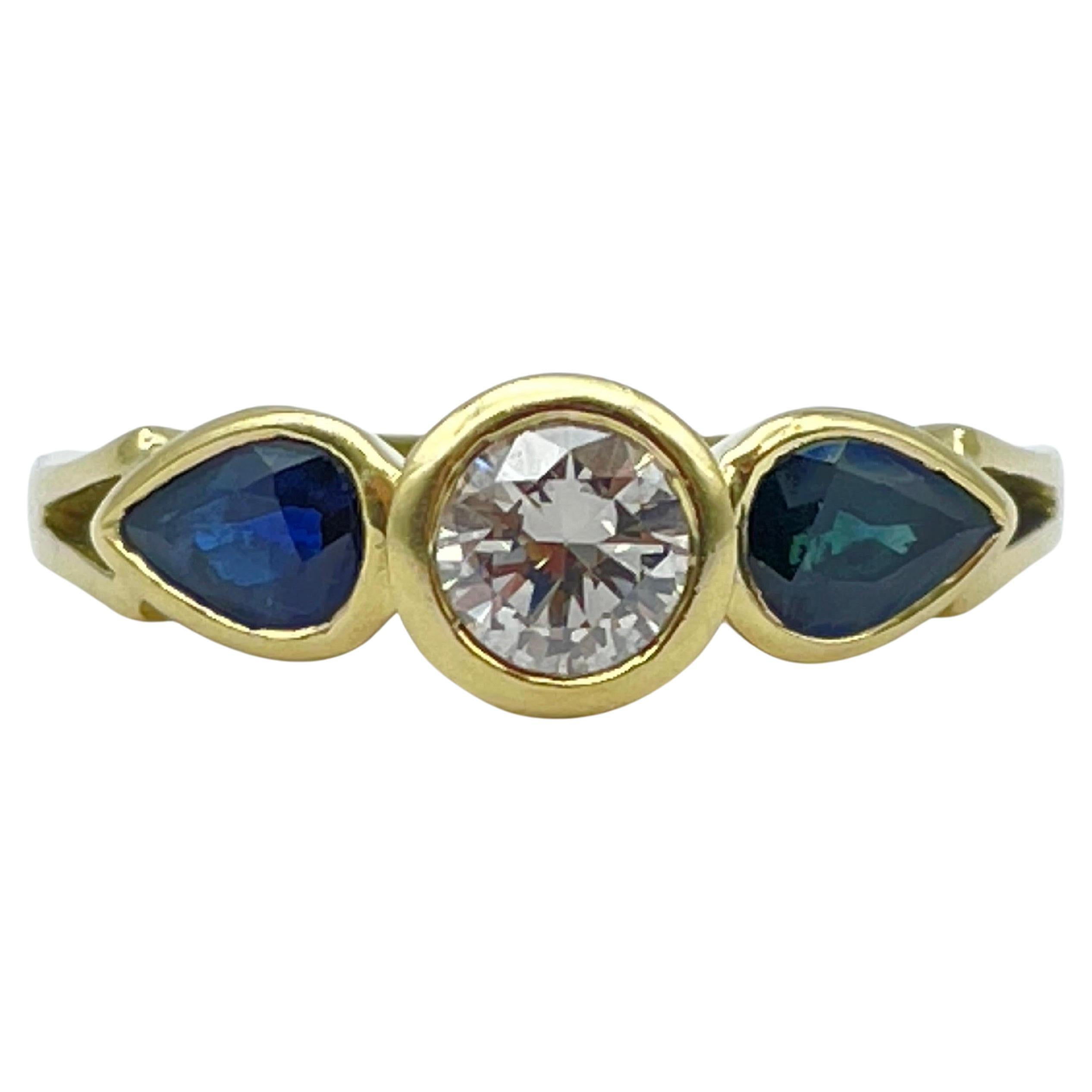 Beautiful yellow gold ring 0.60carat diamond, 2 blue sapphire teardrops For Sale