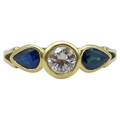 Beautiful yellow gold ring 0.60carat diamond, 2 blue sapphire teardrops