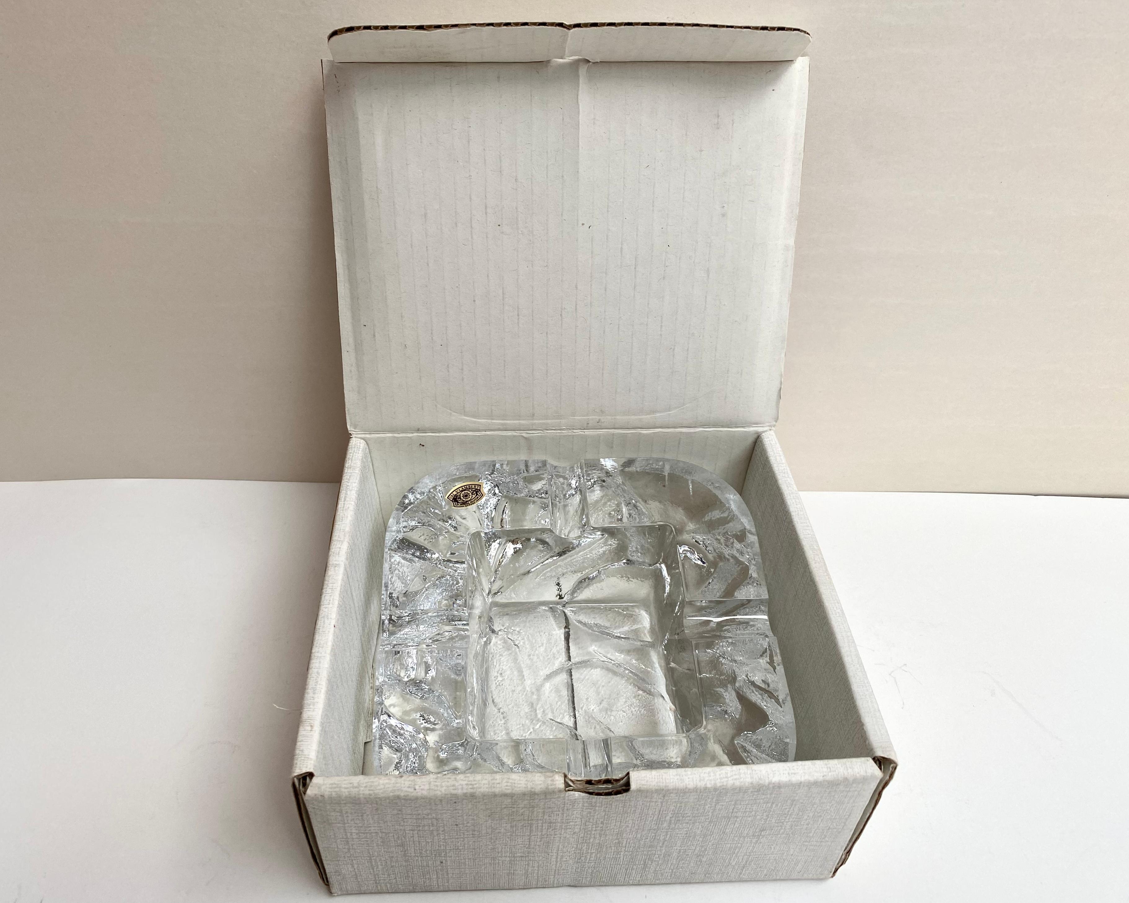 Gorgeous and heavy crystal ashtray. Ice glass effect. New ashtray in the box.

This ashtray is a real work of art, created by the hand of a master - Made in Belgium, VAL S’LAMBERT, in 20th century. 

Crystal ashtray is a wonderful gift for any