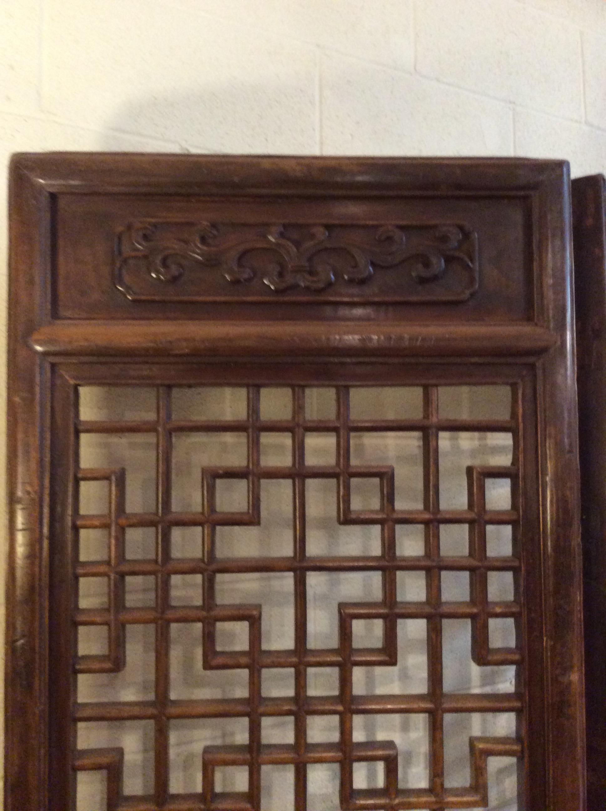 These monumental carved elm wood screens come form the Shanxi Province in China and are approximately 180 years old. The carvings at the top, middle and bottom signify good luck and happiness.
The open fretwork at the upper half of each panel