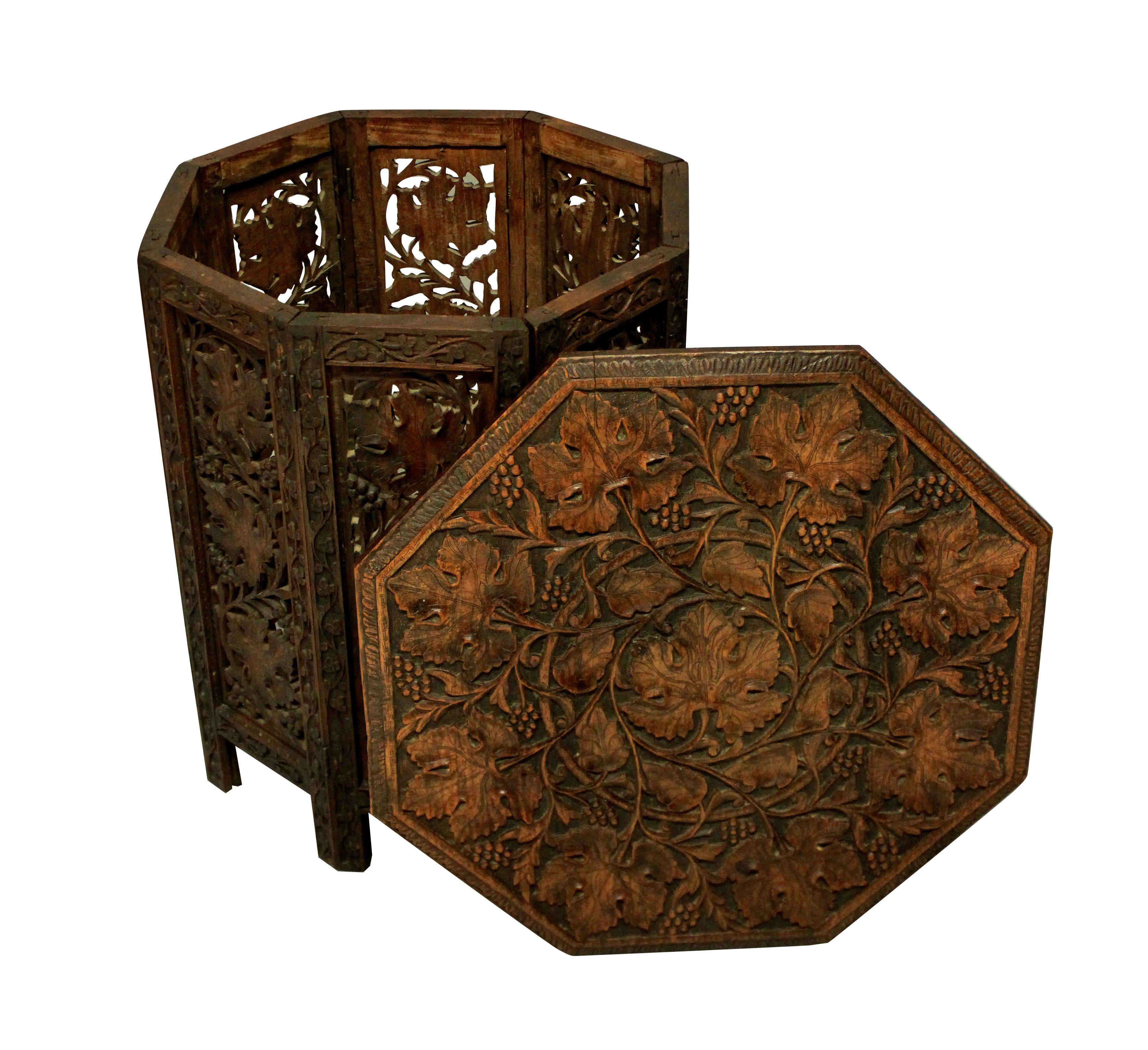 A beautifully carved Moorish side table, which folds flat for travelling. Depicting vines, it has a good original patina.