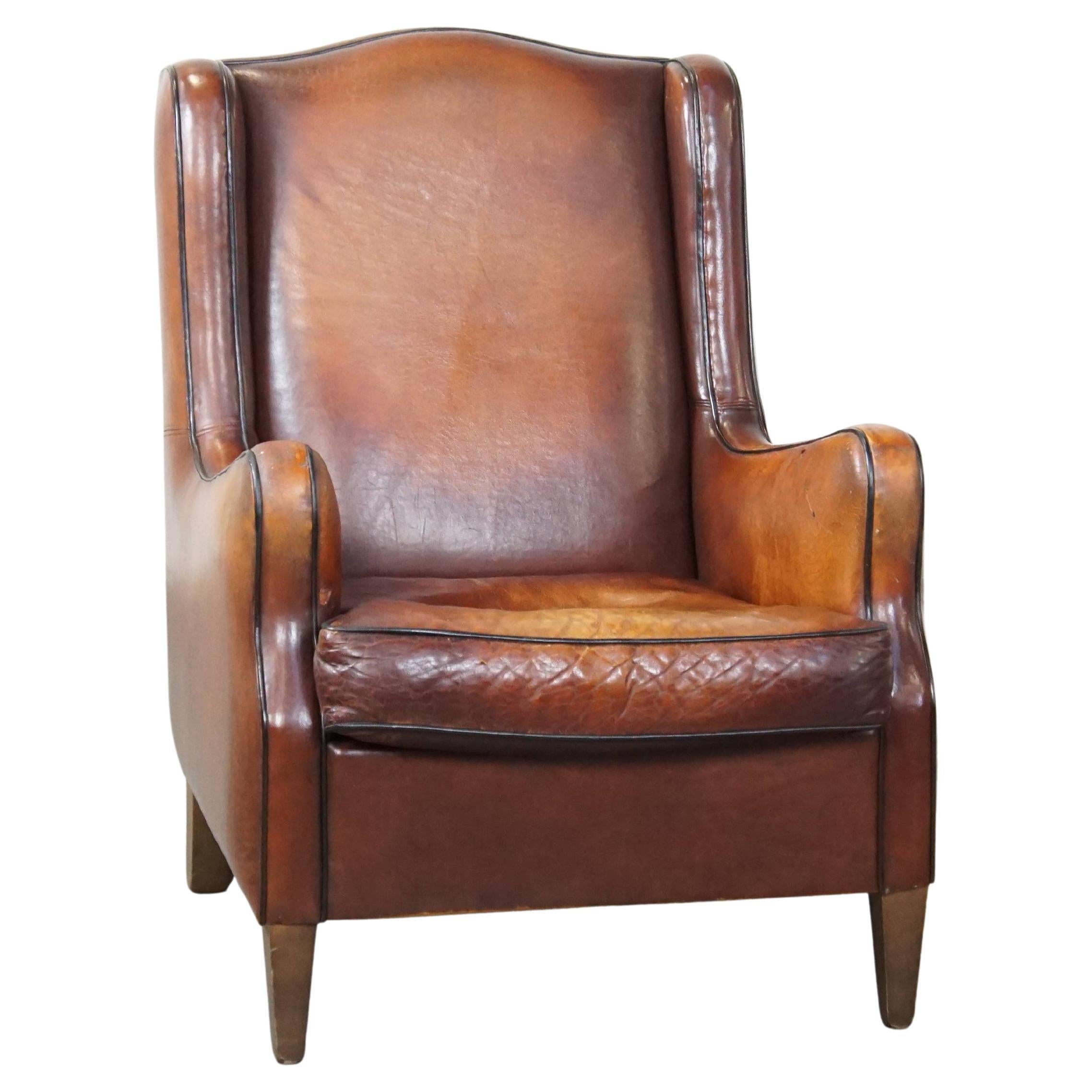 Beautifully colored, rugged vintage sheepskin leather armchair with a high back