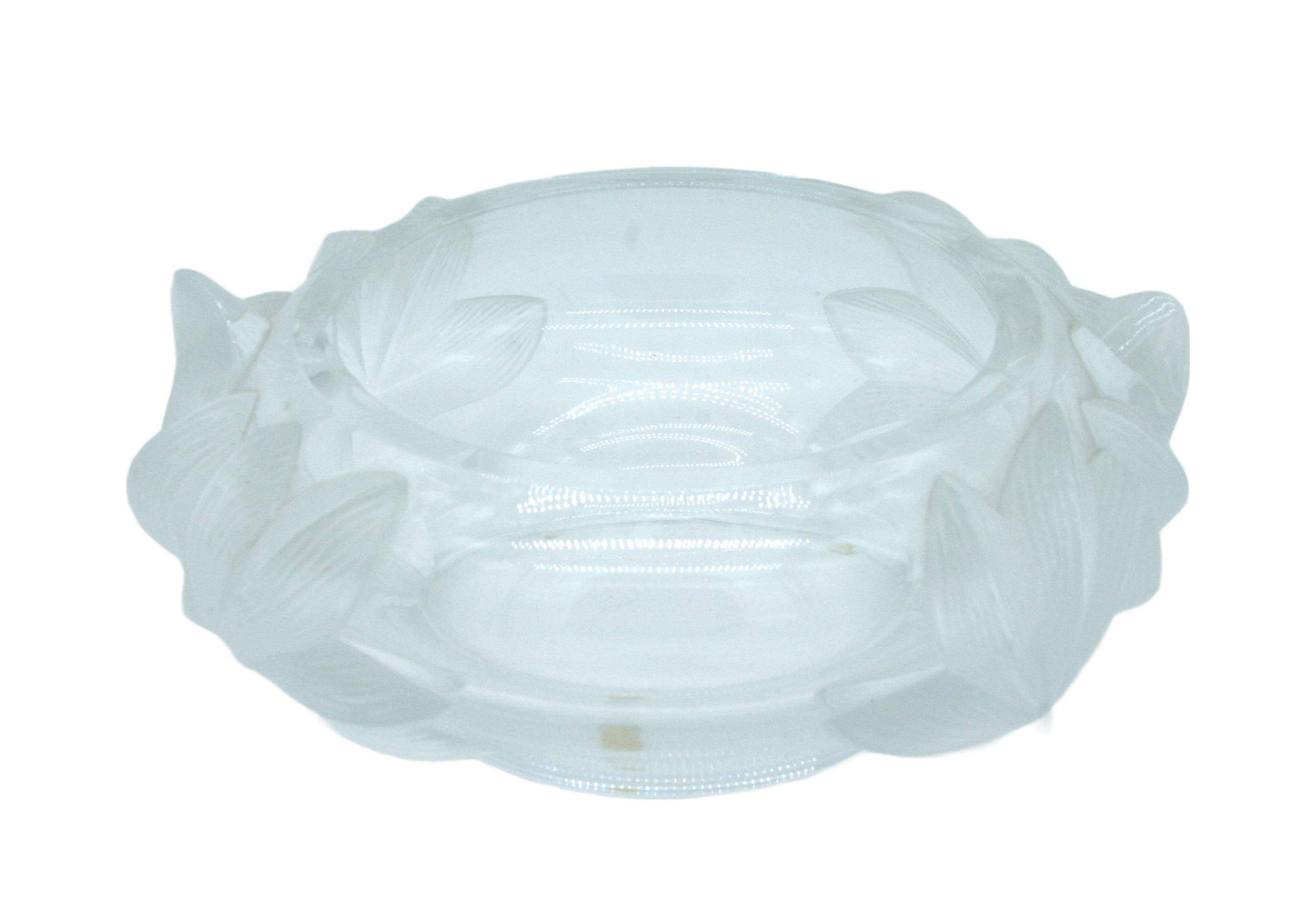 Beautifully crafted Lalique decorative centerpiece bowl with exterior design details. The piece is in great condition. Minor shelves wear. Maker's mark underneath. The centerpiece bowl measures about 11 inches diameter x 4 1/2 inches high.
   