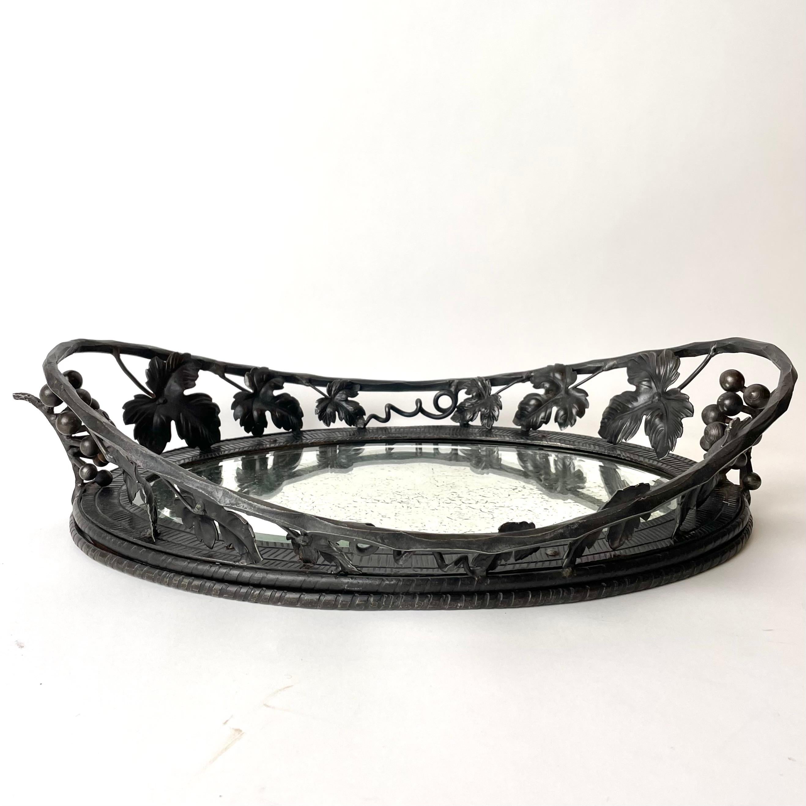 Beautifully decorated Fruit Bowl in wrought iron from the 1920s. Elegantly decorated with grapes and grape leaves. Faceted mirror glass with a charming patina. (See pictures)

Wear consistent with age and use.