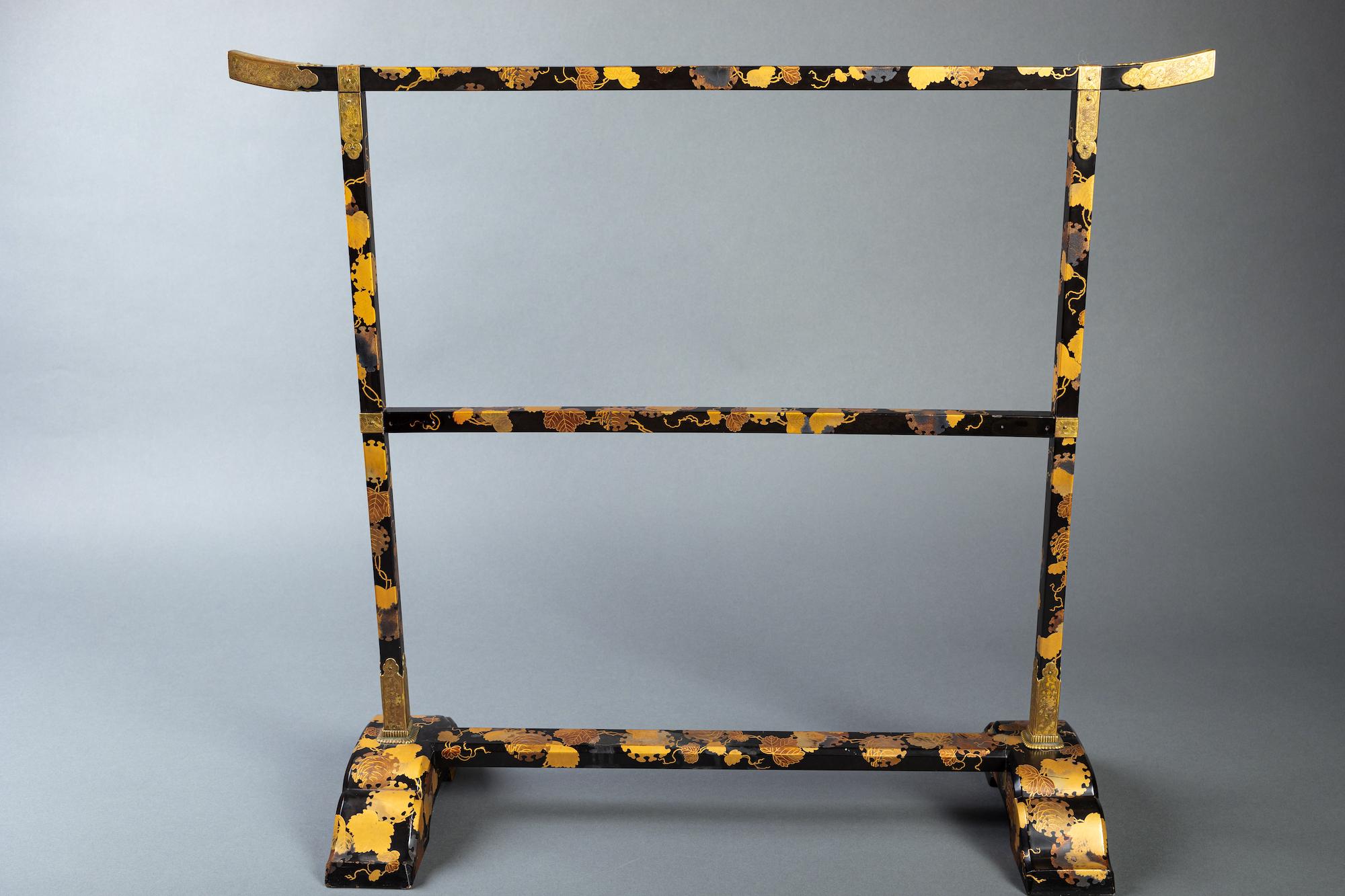Mid to late 19th century, originally produced as a towel rack for the tea ceremony in black and gold lacquer on wood, with beautifully decorated bronze mounts.  