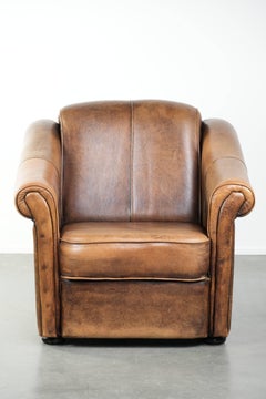 Beautifully designed and comfortable sheepskin armchair with black piping