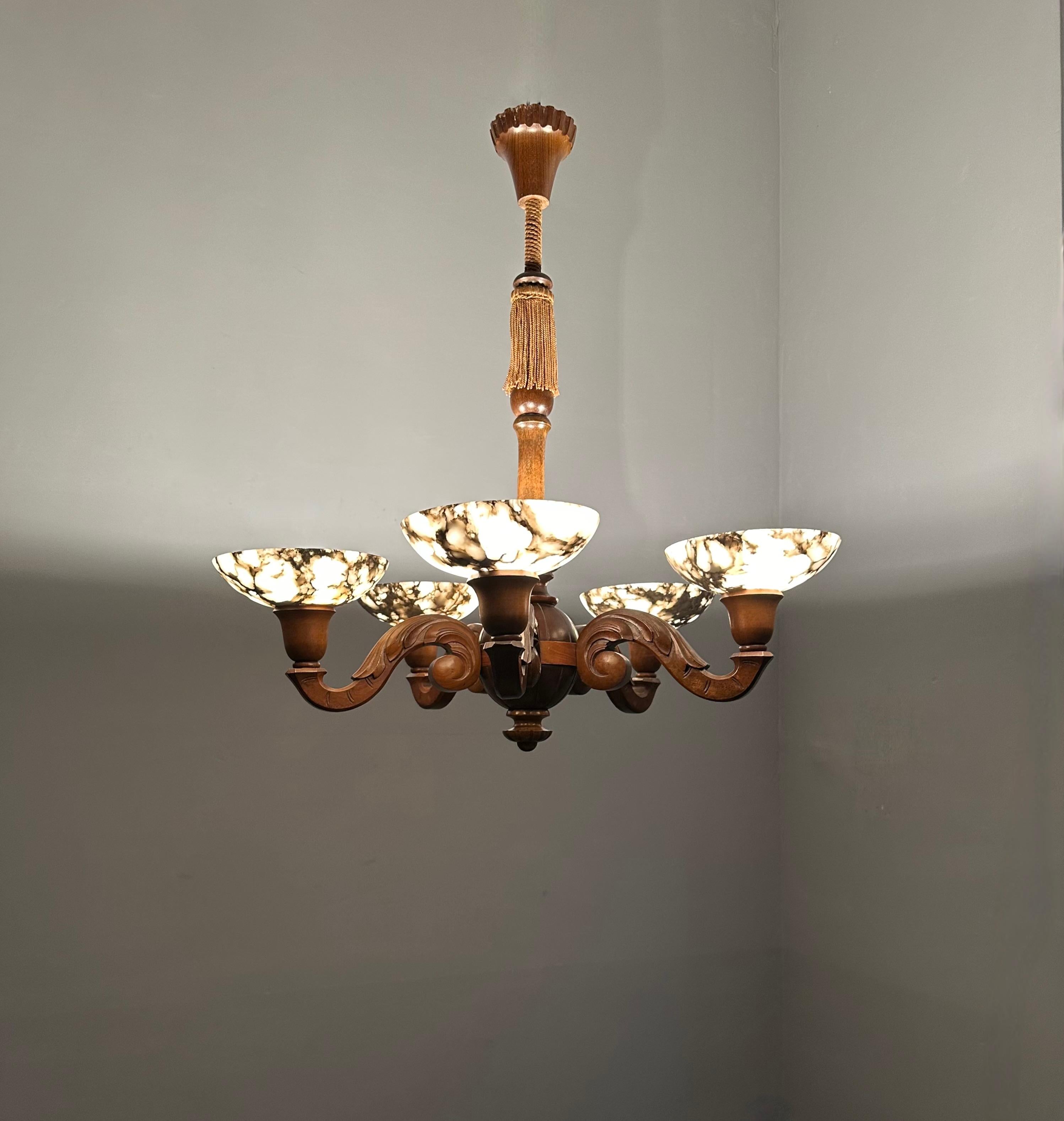 Good size and striking design, early 20th century pendant.

This antique, five-light chandelier from the Arts & Crafts era is another one of our recent great finds. The wooden body and arms are in the best possible condition and they come with a