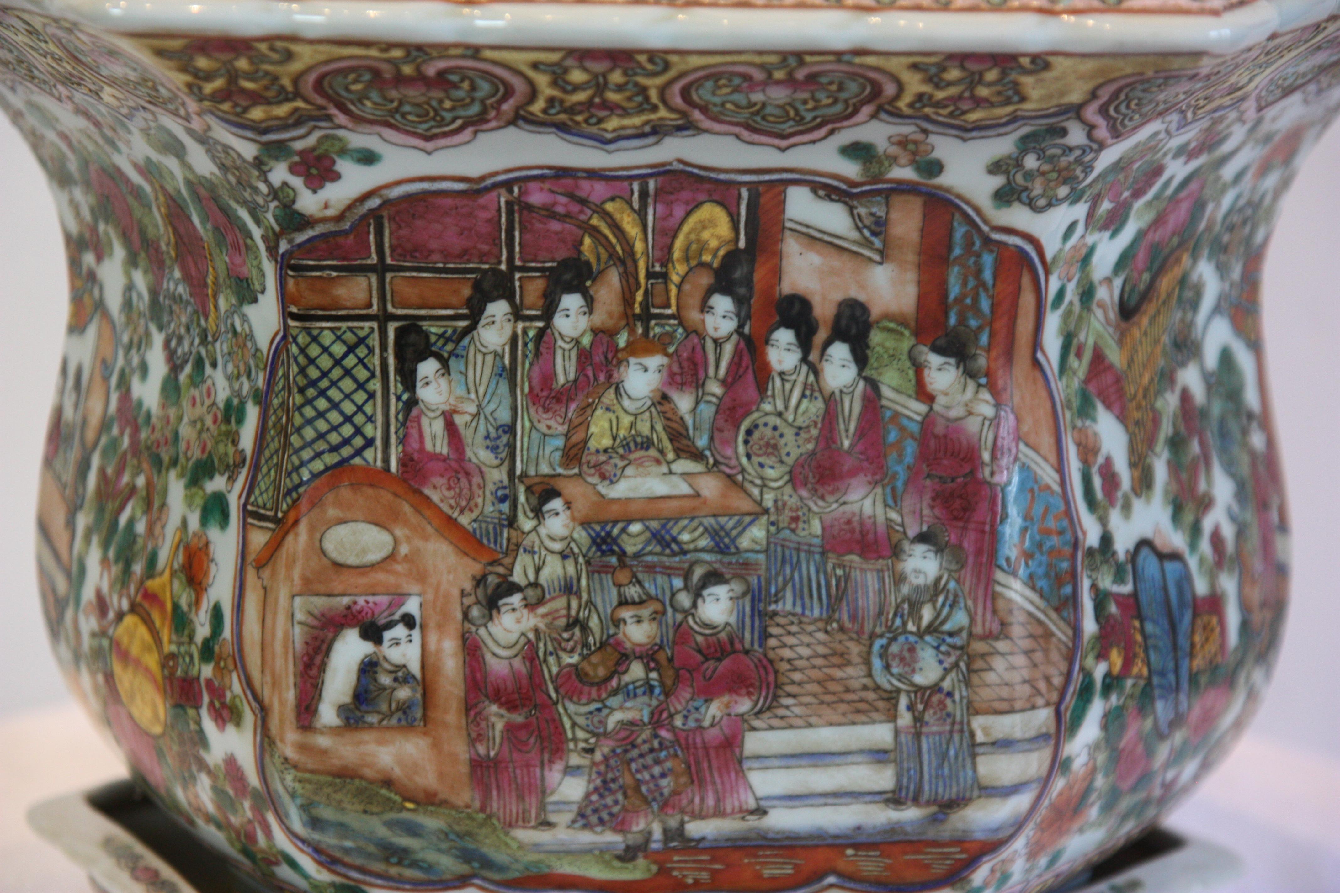 Hand-painted octagonal jardinière with plate. Images of a royal scene, flowers and animals adorn the piece.